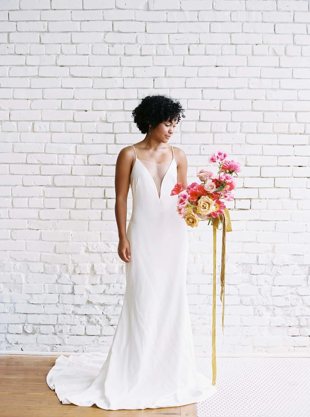 Bride with her bridal blooms designed by Color Theory Collective