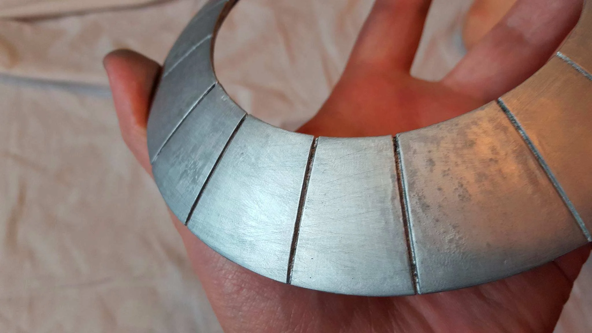 I took two of my better segments and tried some texturing. I used some rough grit sand paper to make a bit of brushed look. You get a good look at some of the splotchiness left from poor application. 