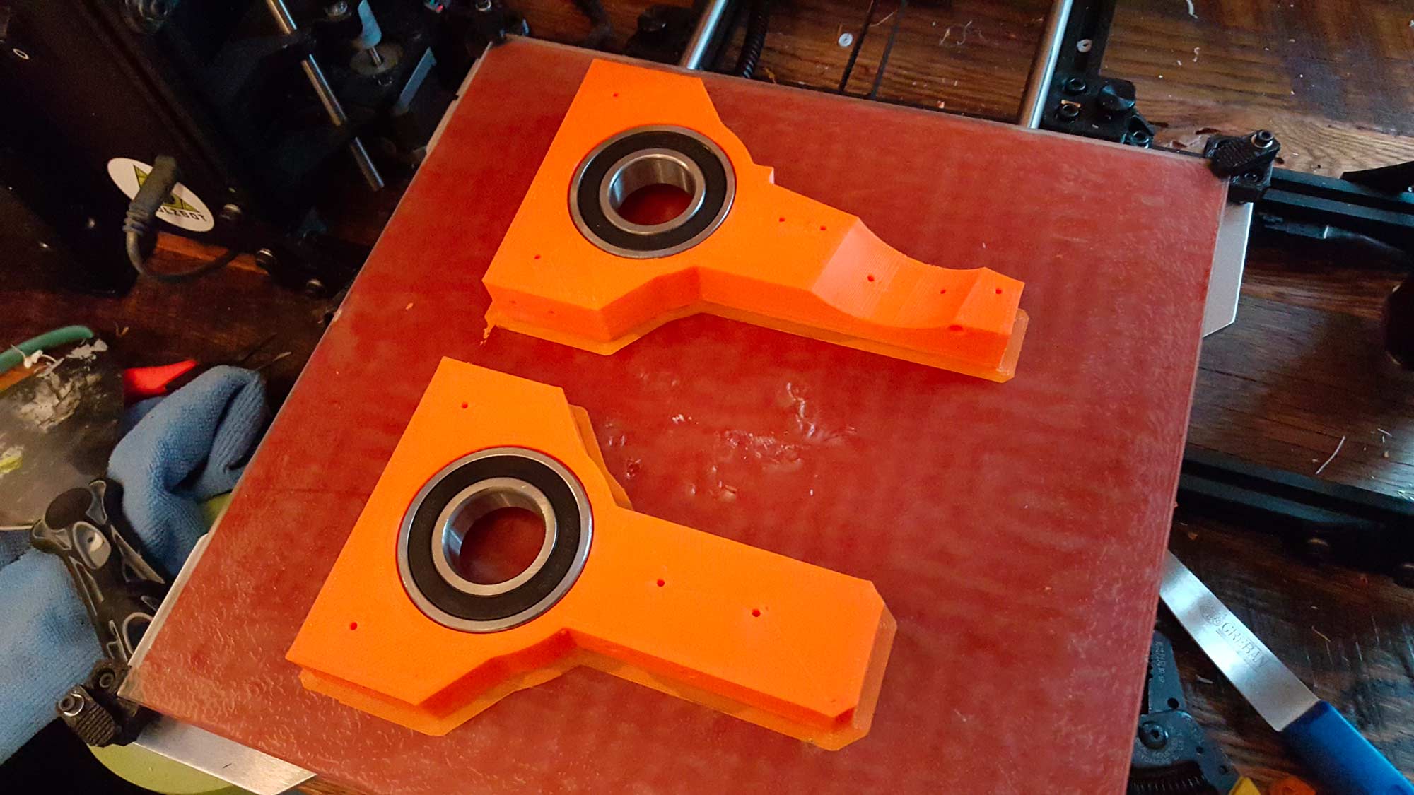 This print I am super proud of and have to give myself a little pat on the back. I printed the "trousers" which have a recess for a bearing that will go around main axis. As soon as the print finished I test fitted the bearings and thankfully they fit. Then the genius part....I decided to leave the bearings in the hot print on the bed. As the plastic cooled it contracted around the bearing and the bearings basically installed themselves. Those suckers are in there for good with no glue or anything.