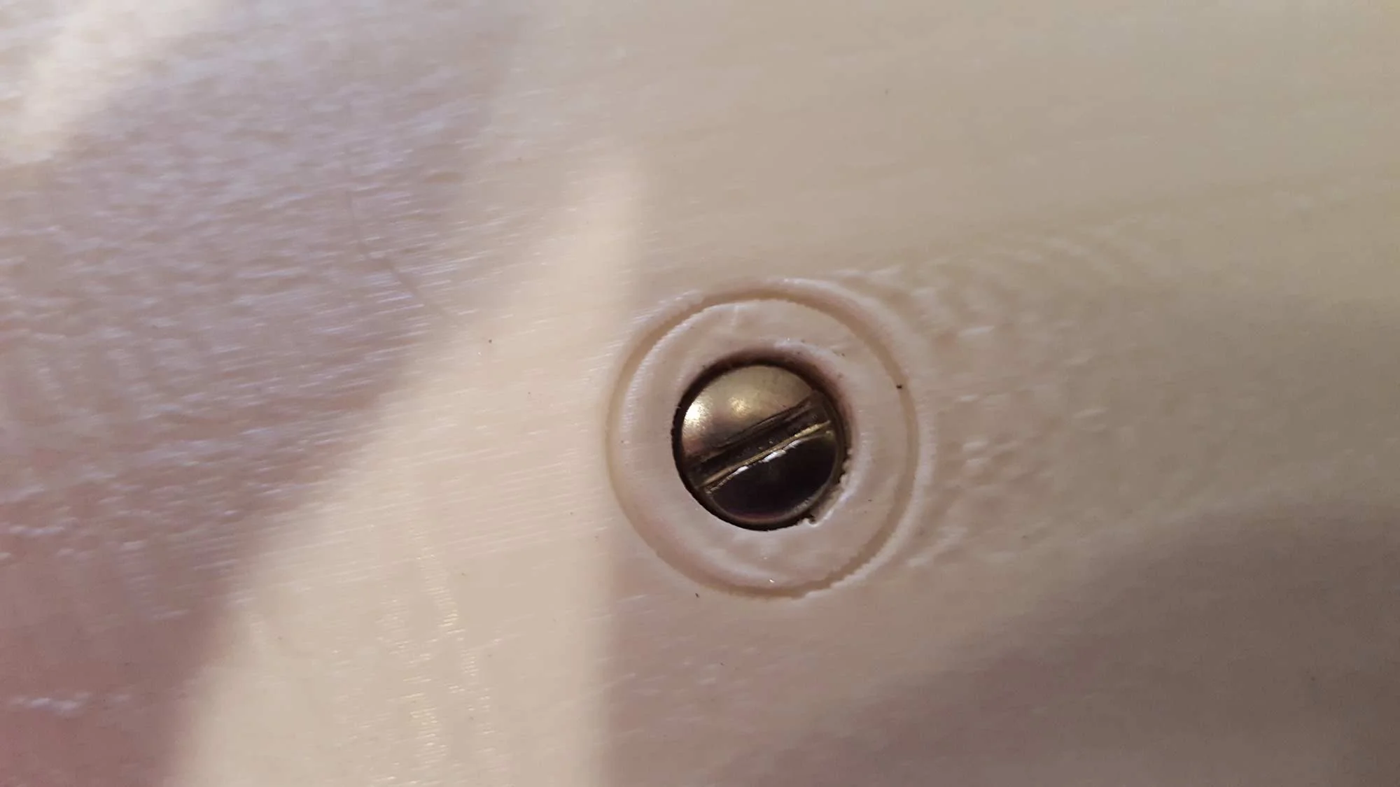 Forced into place with the screw