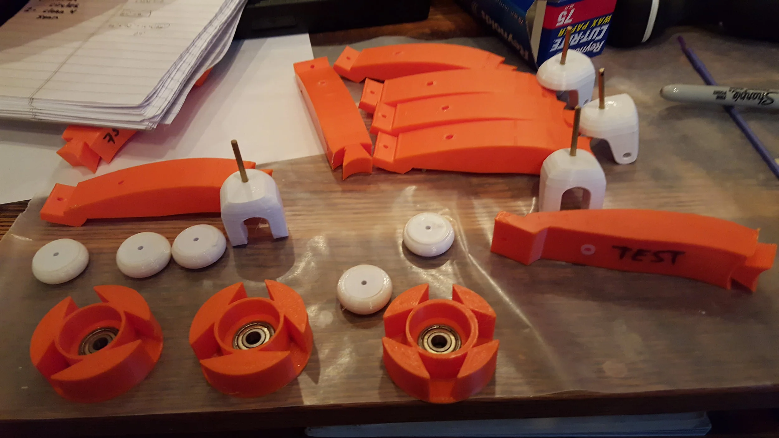 I also managed to print out all my wheel hubs and new tires. The problem I mentioned above with the old version was the axles in this assembly. They were 4mm steel which (1) heavy, (2) attracted to the magnets which lead to a ton of problems. So I went with 3mm brass this time which is significantly lighter and not at all affected by the magnets. I also decided to use white Semi-Flex for the tires this time around. The black/green of the previous rounds were leaving scuffs on the cheese wheel. One of their sample spools was enough to create 12 wheels. 