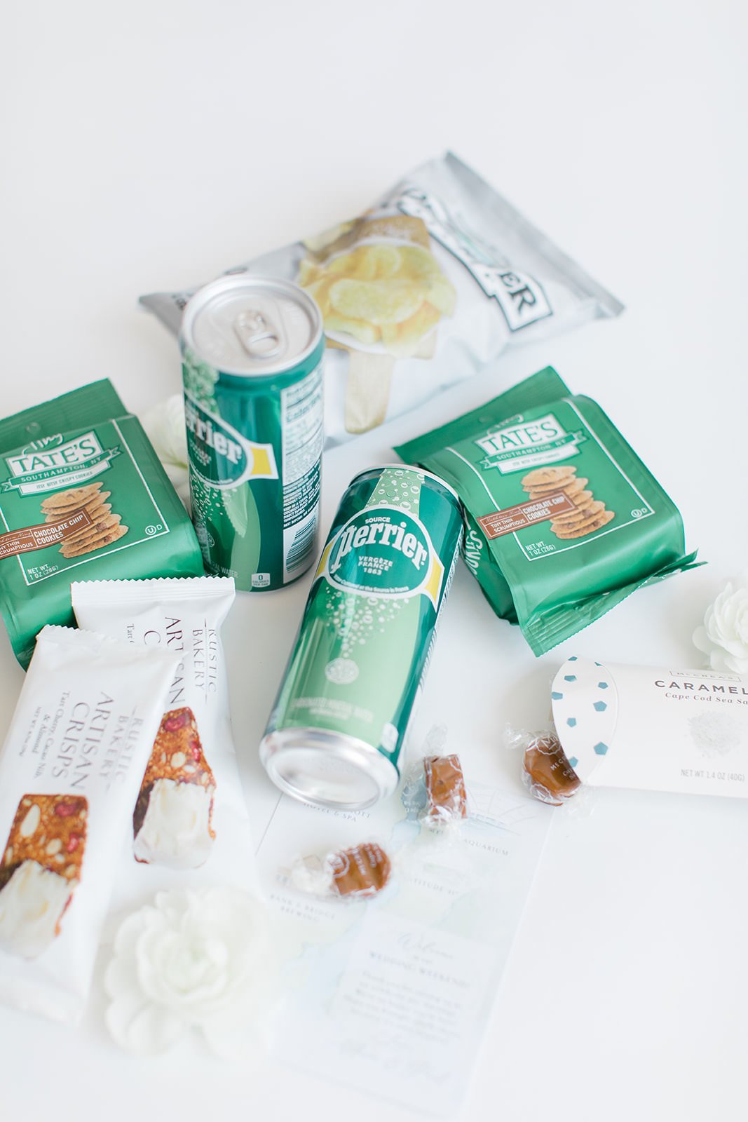 chocolate chip cookies, chips, drinks and snack bars in wedding welcome bag