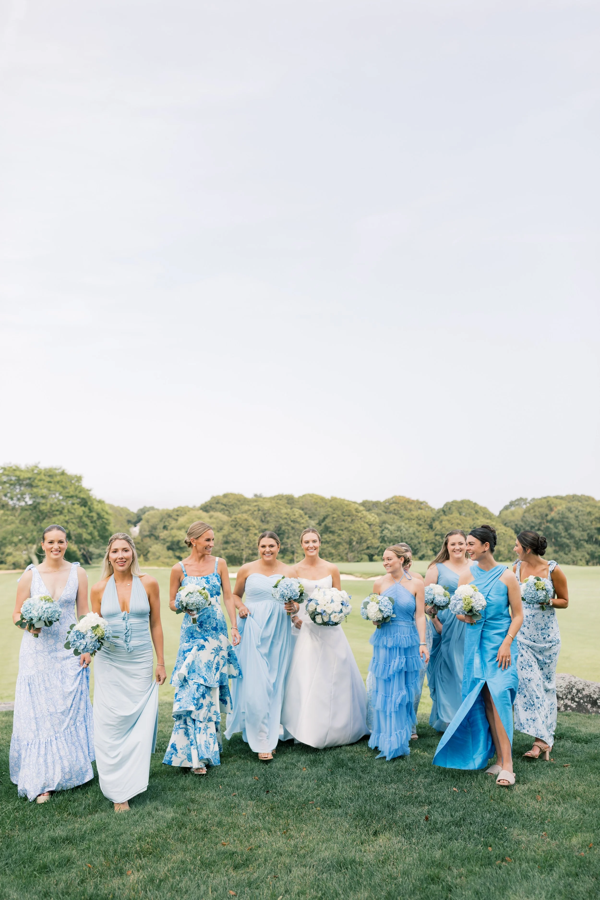 bridesmaids wearing mismatched blue at watch hill wedding