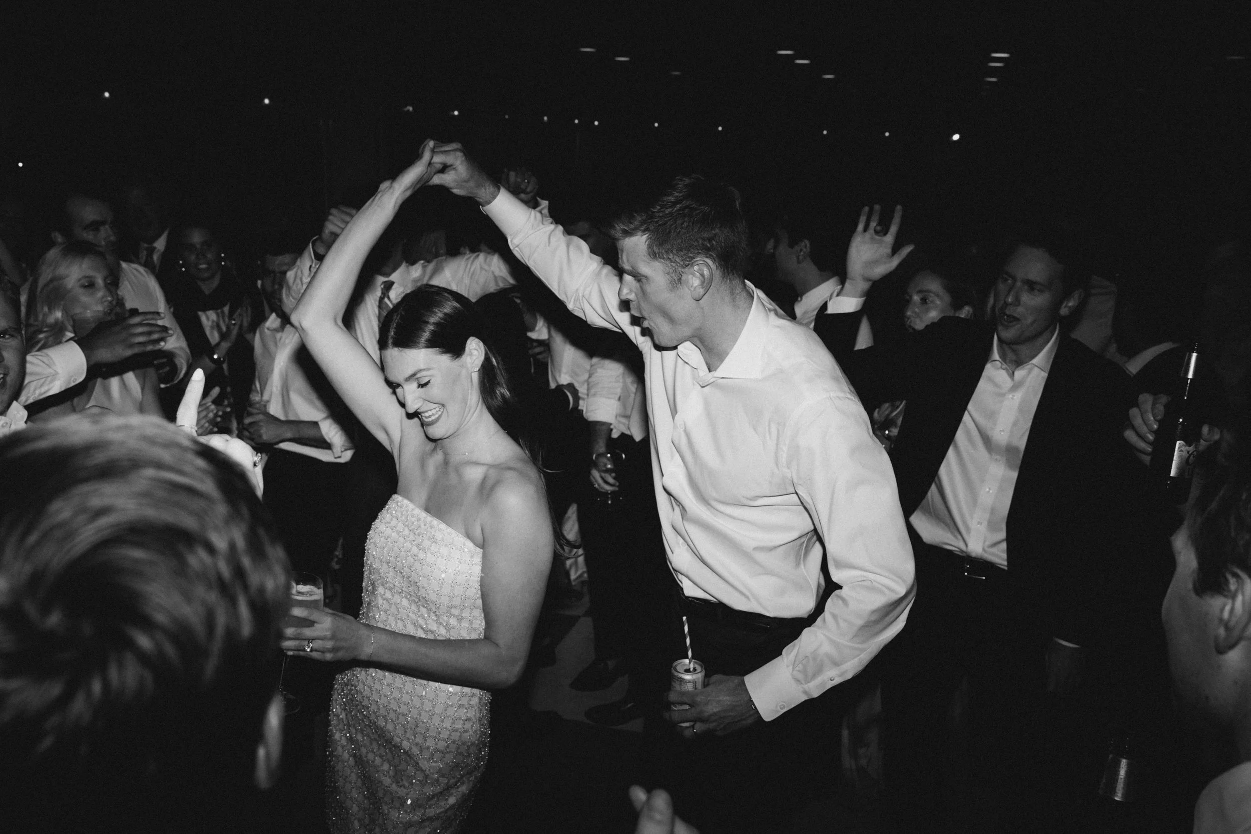 black and white image of couple dancing at reception