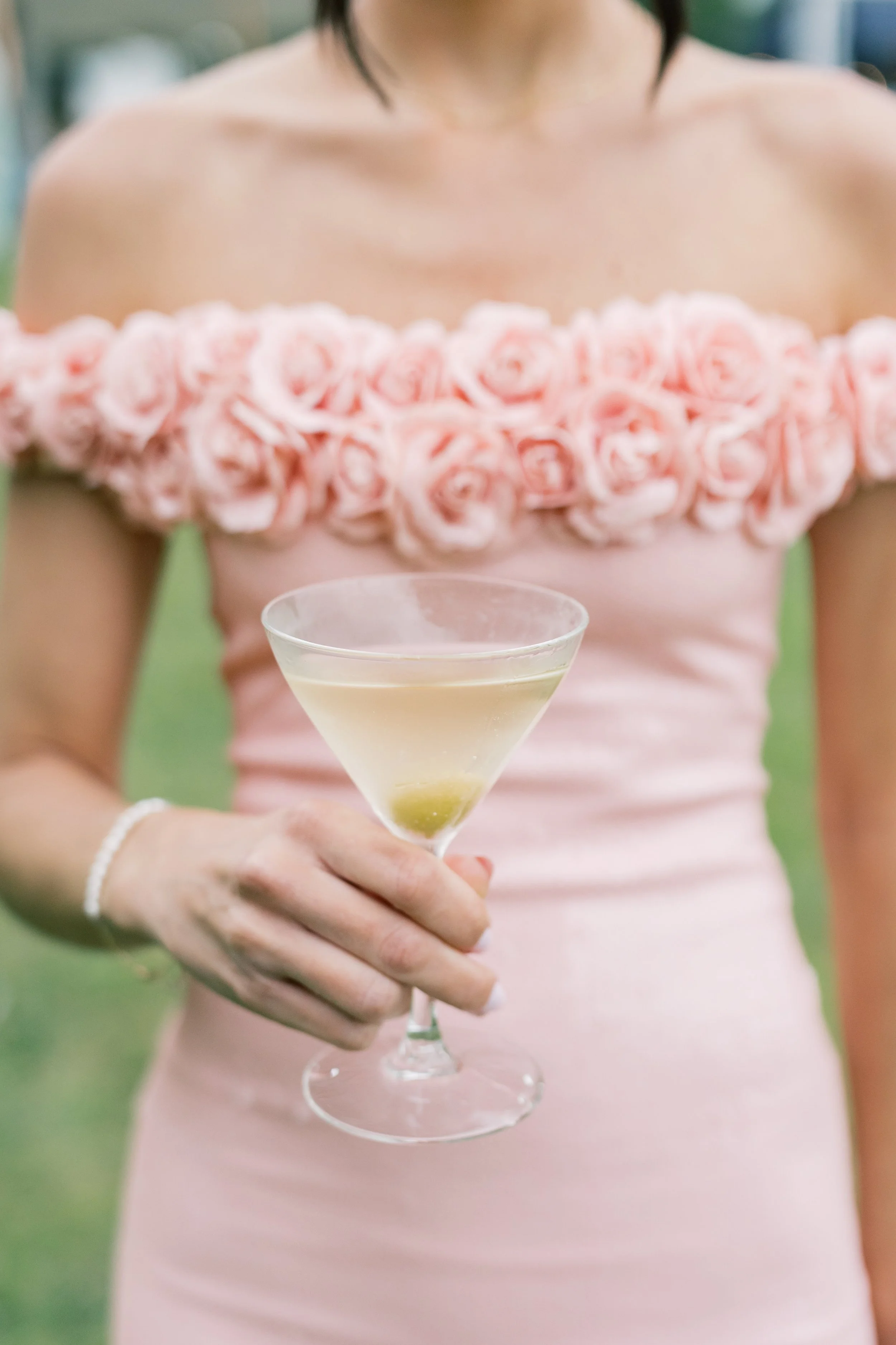 woman in pink dress at wedding holding a cocktail