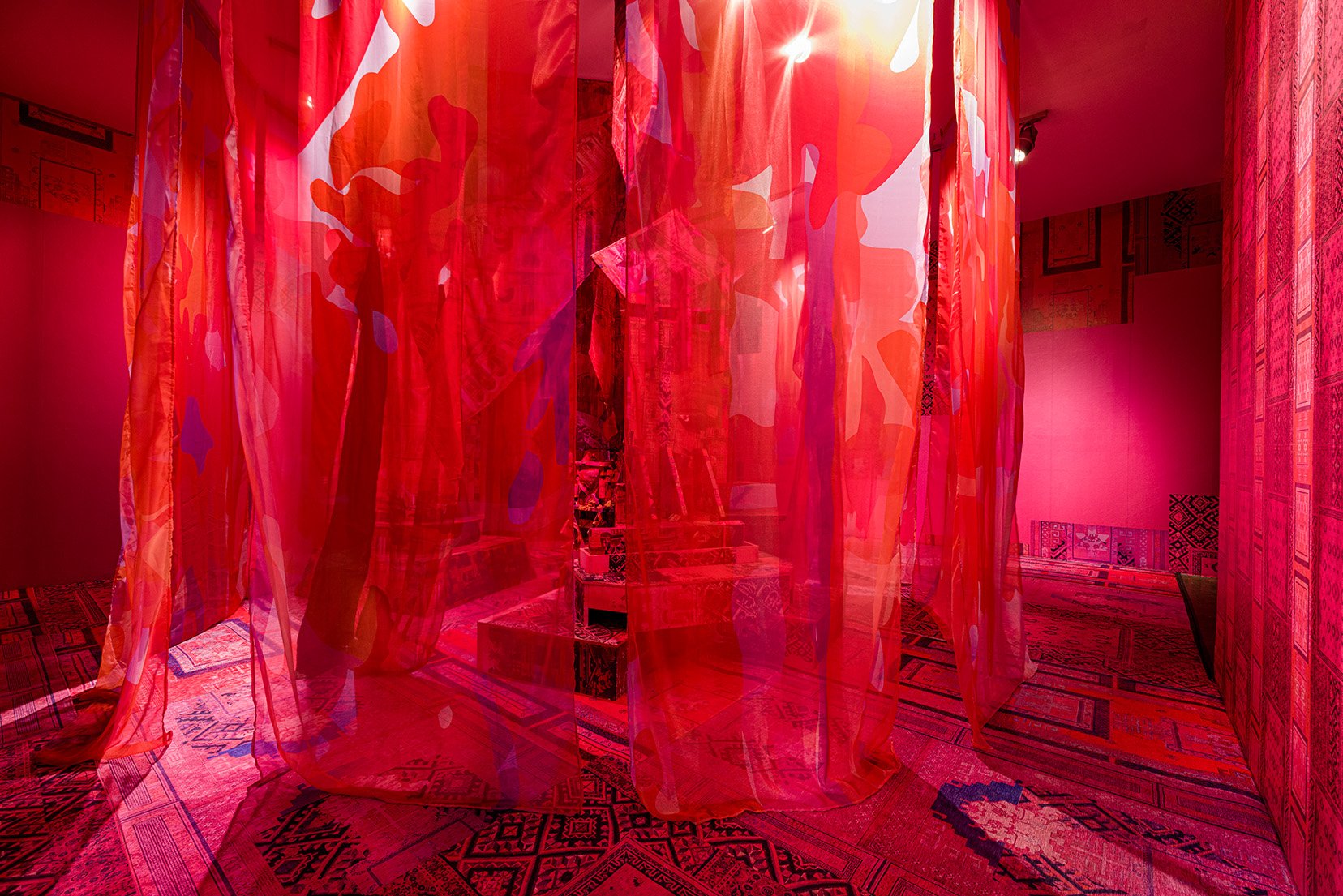 "Roots Burrow Through Stones and Hard Facts", 2021, textiles, carpets, foam and wood sculptures, wallpaper, motion detector, 3 speakers with sound, 26 x 24 x 12 feet. Photo: Etienne Frossard (scroll down for description of the project)