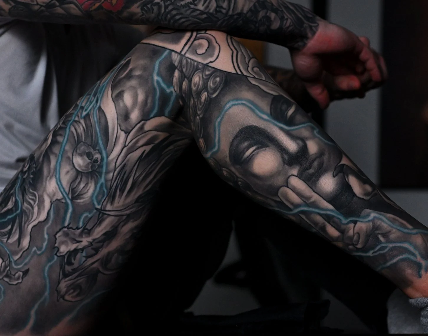 thunder buddha  Men's neo japanese asian leg sleeve tattoo with blue lightning highlights  asian artist: Kai 7th Samurai. YEG Edmonton, Alberta, Canada 2023 best 2024 