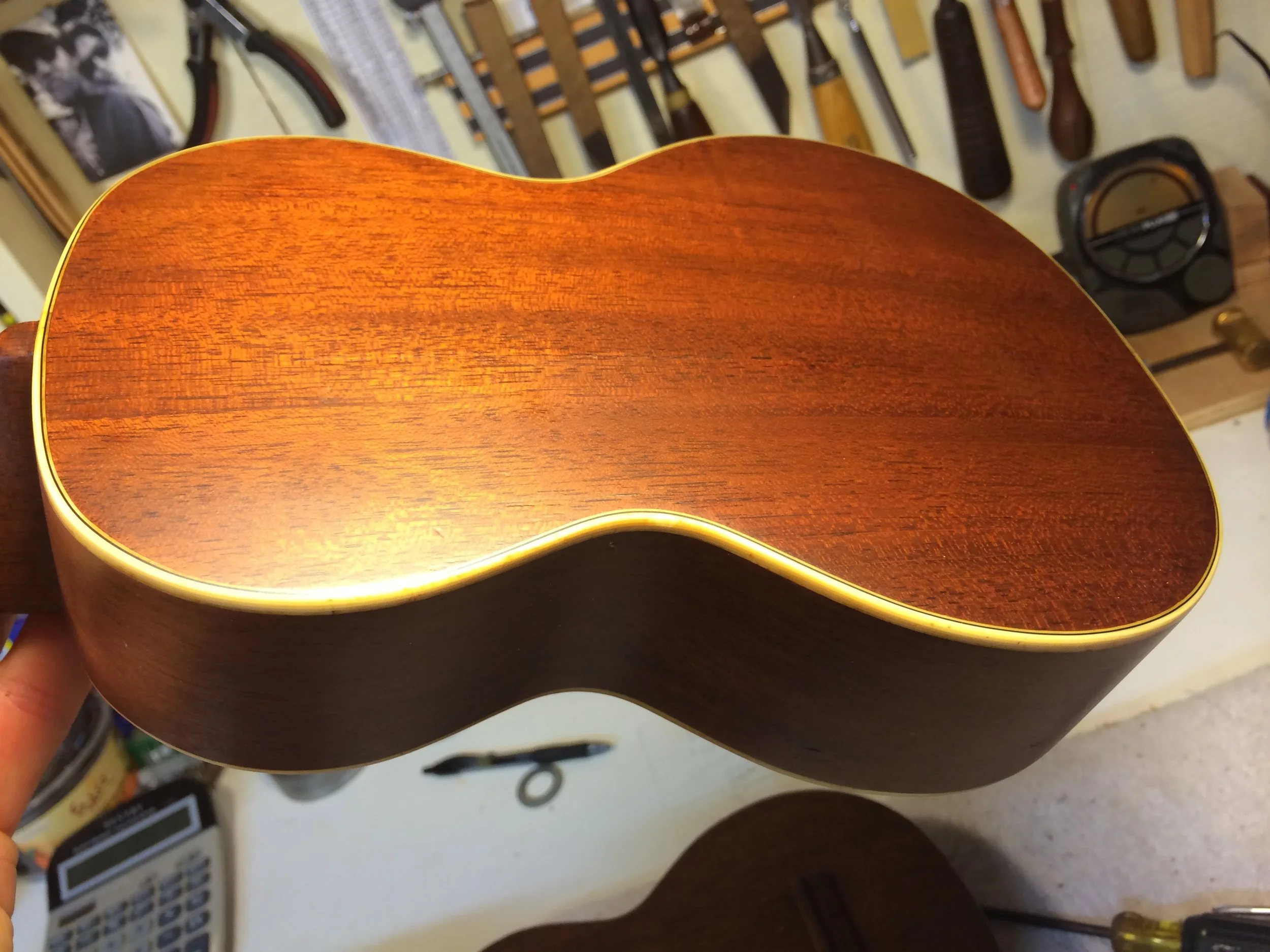 A replaced back, with the original binding saved and tinted for the warm glow of vintage nitro cellulose.