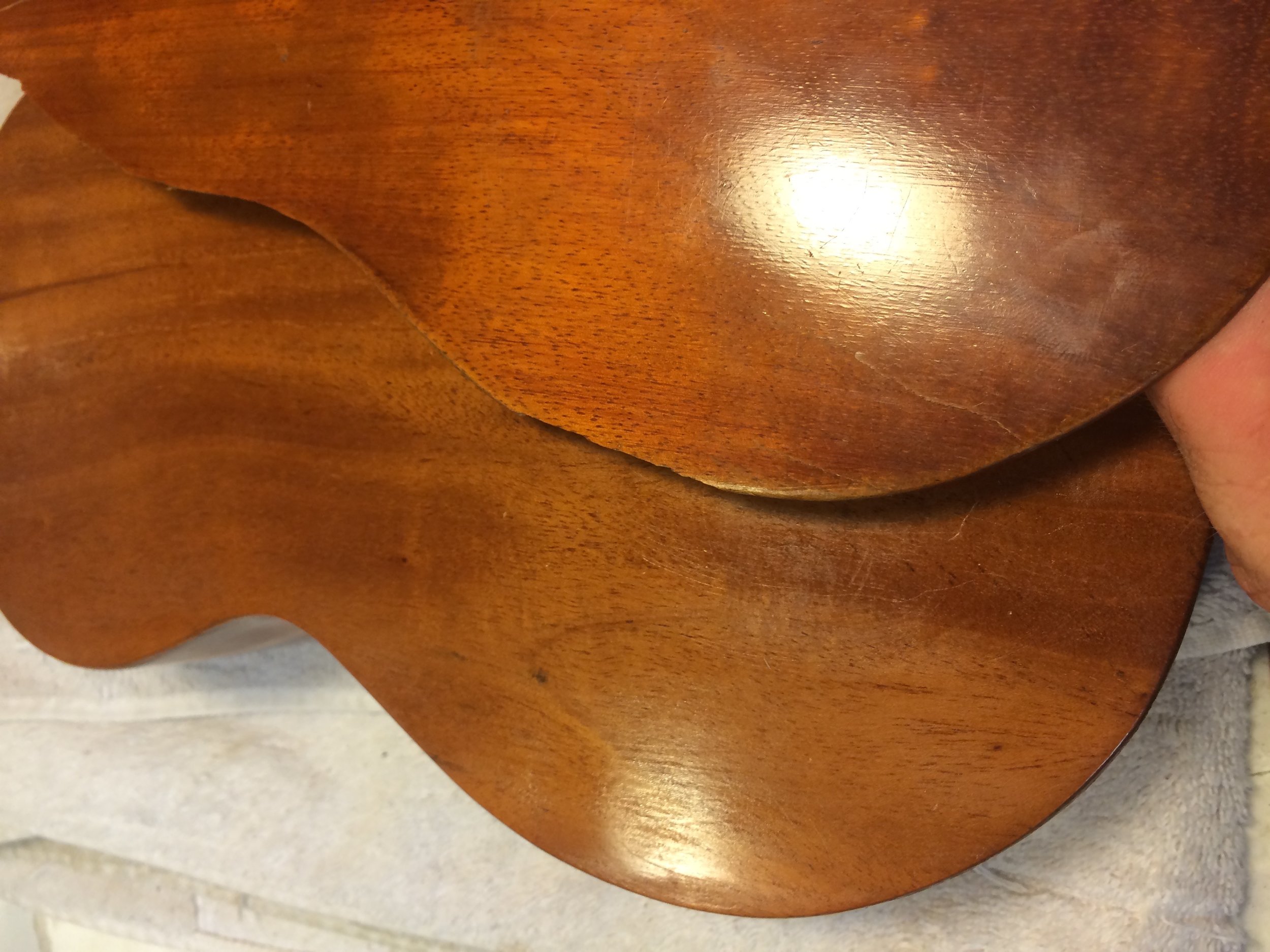 The back of this uke was badly cracked and missing pieces, my client asked that I replace the entire back. I found a good match of Koa, and made a custom varnish to match the aged patina.