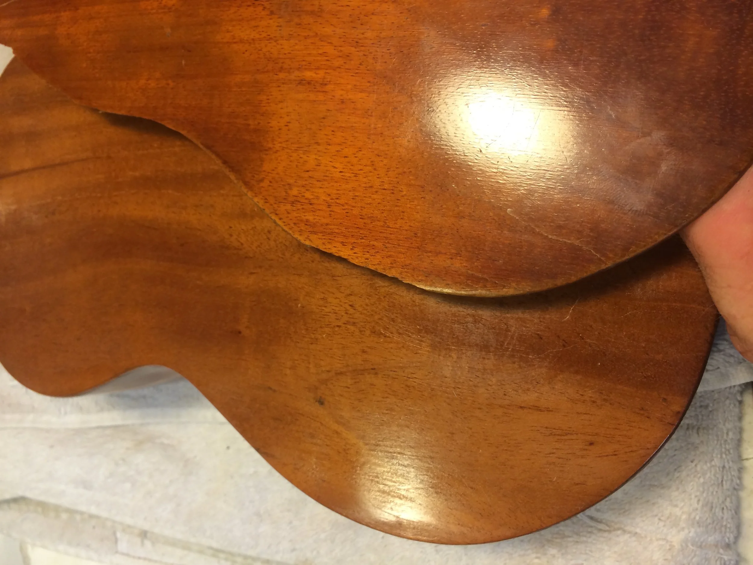The back of this uke was badly cracked and missing pieces, my client asked that I replace the entire back. I found a good match of Koa, and made a custom varnish to match the aged patina.