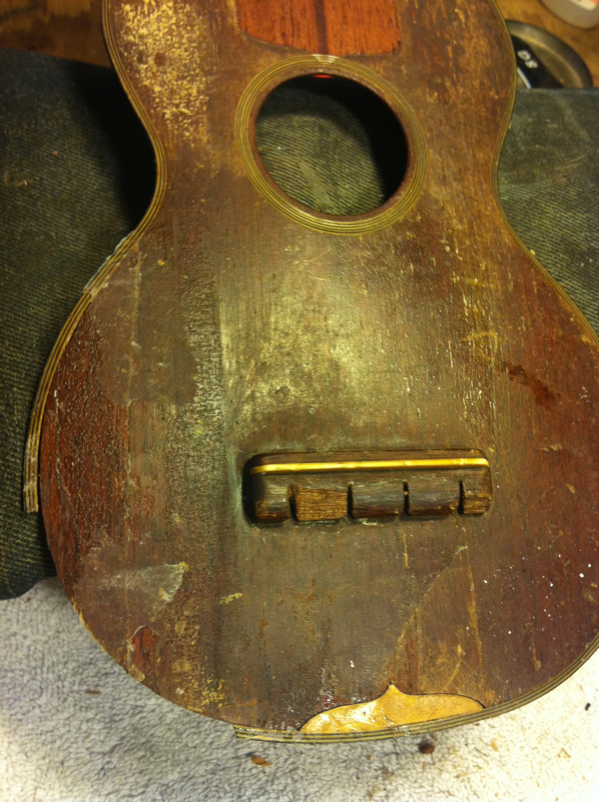 Several restorateurs had turned this job down, but the emotional appeal of the owner won me over to the cause. The uke had belonged to his father, and he had attempted the repair work as a young boy.