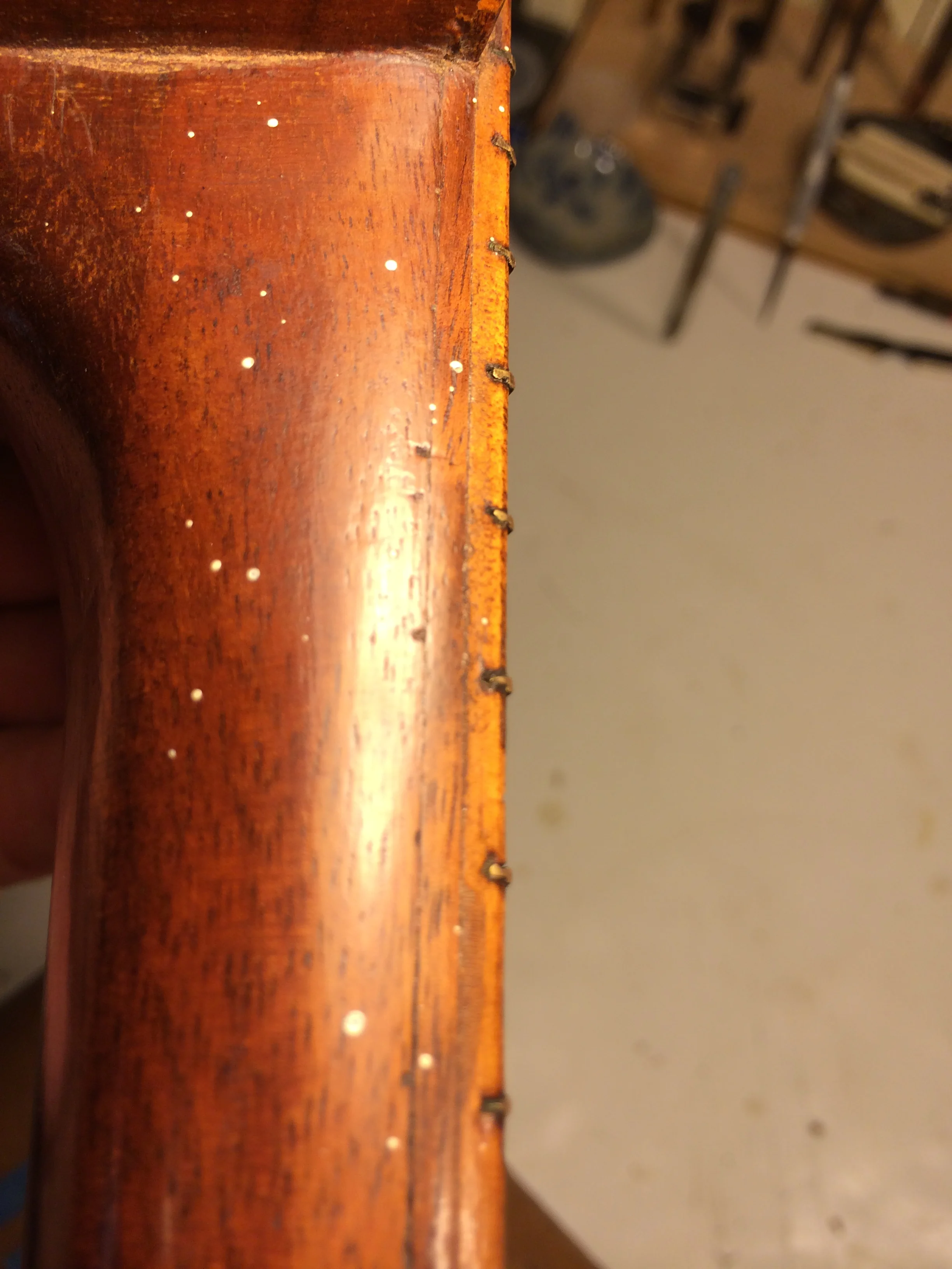 Then I noticed these two very small indentations below the second layer of Koa. Could they be old fret slots? 