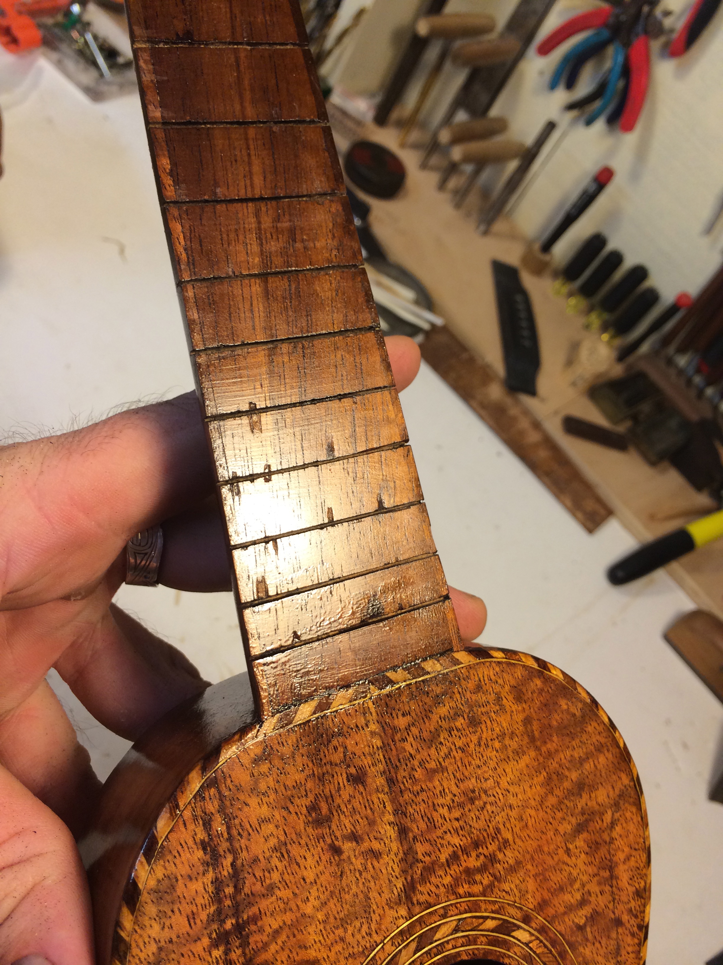 These early ukes often had light finish over the fingerboard, These little chipouts are going to disappear.&nbsp;