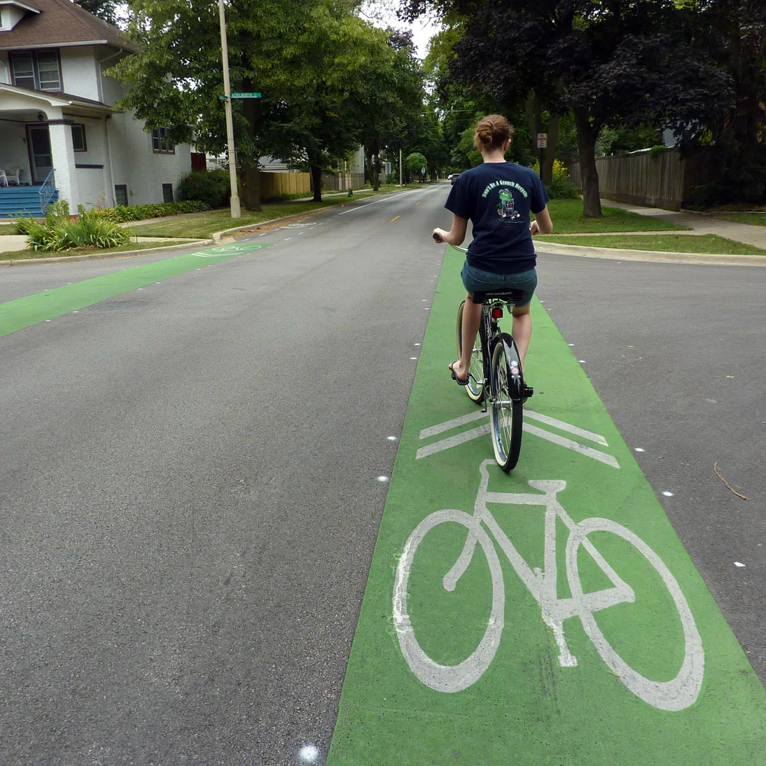 Girl riding a bike in the bike lane.