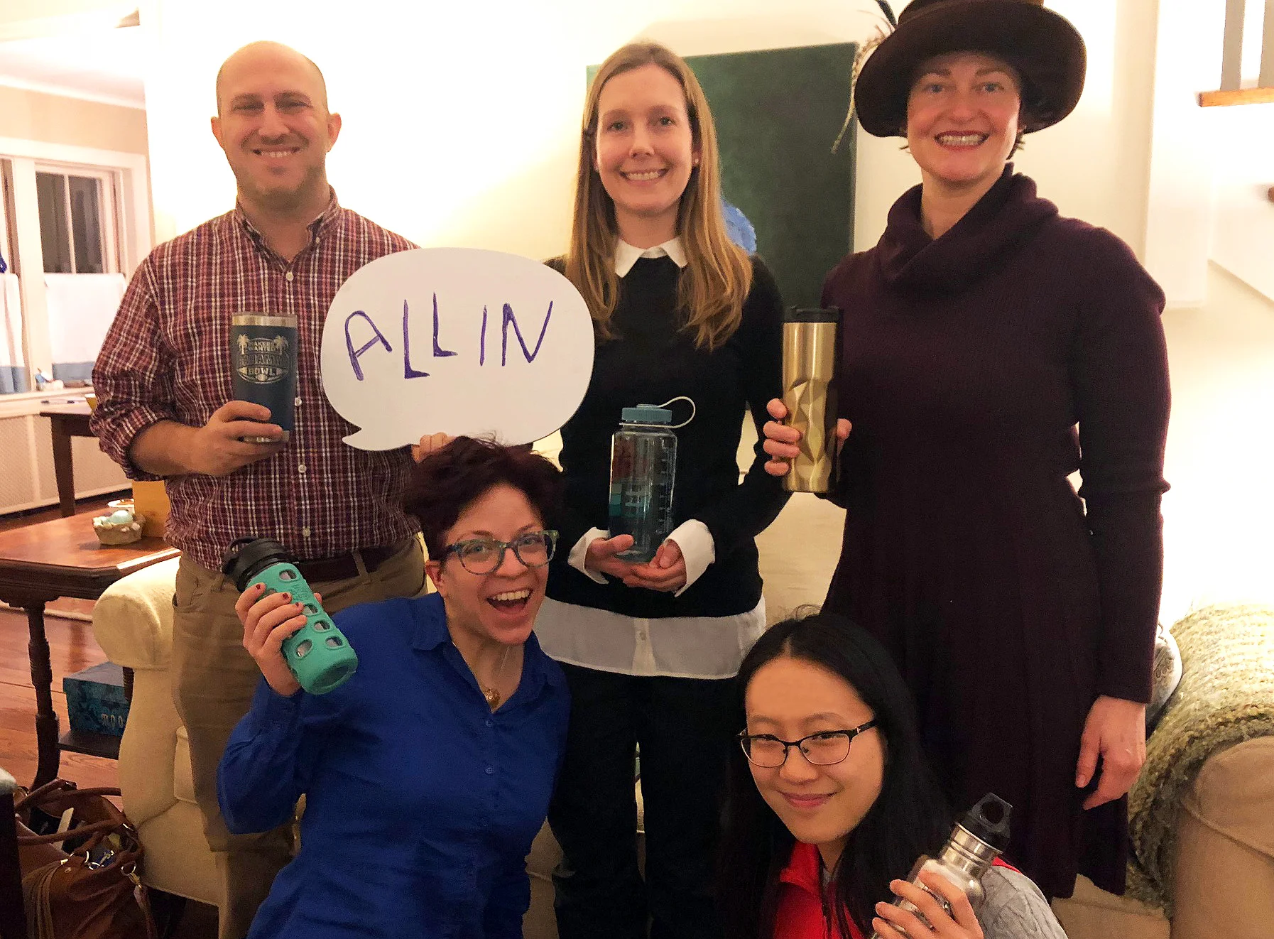 Marketing Team holding water bottles to prove they are all in.
