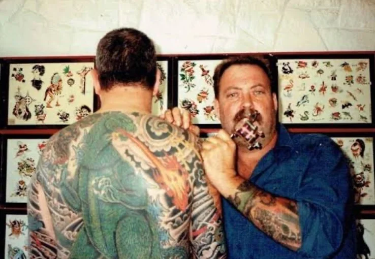 Mike Malone tattoo artist with client