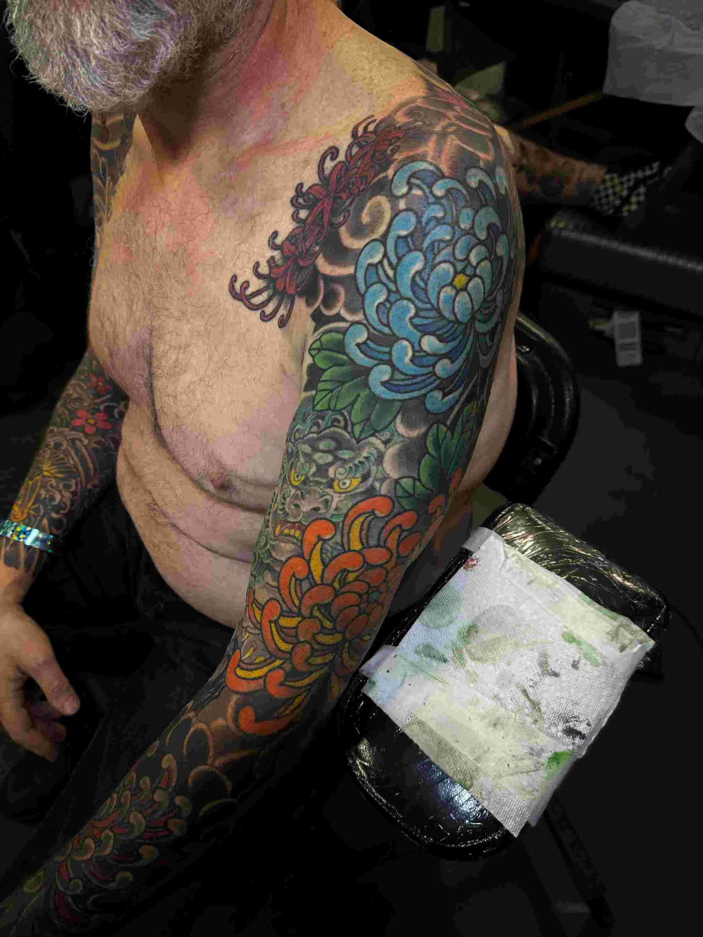 Japanese chrysanthemum sleeve with a foo dog  tattoo by Chris Cockrill
