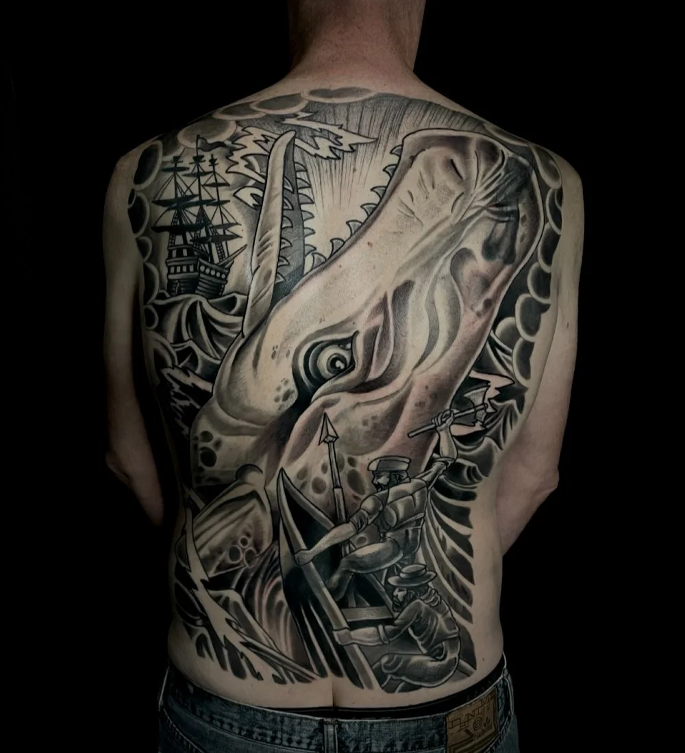 Black and gray ship and whale large back tattoo