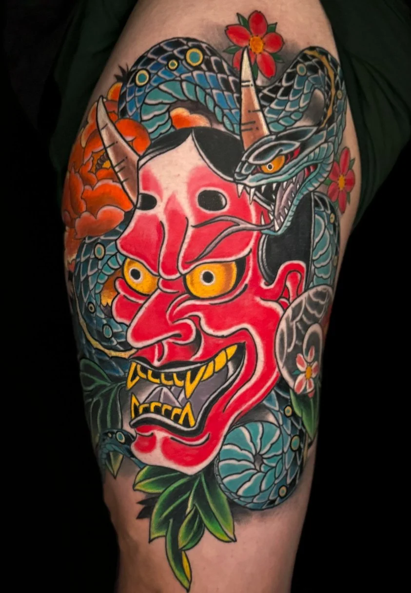 japanese hannya and snake tattoo on an uper thigh 