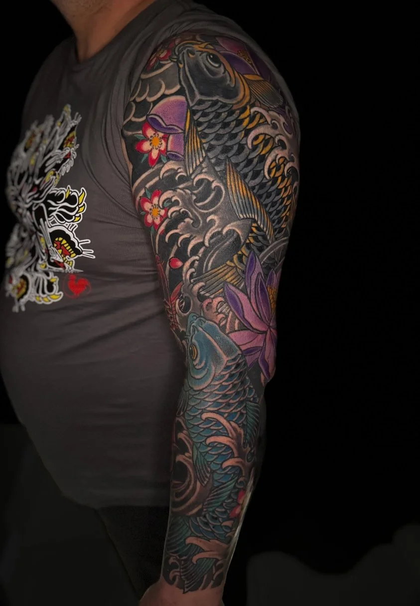 japanese full sleeve tattoo with koi fish and lotus flowers 