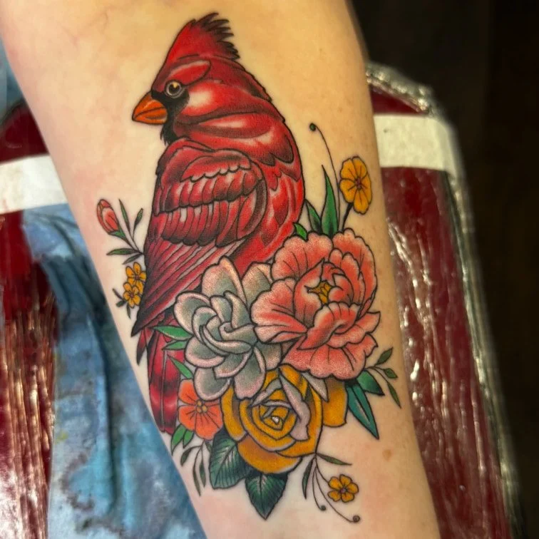 Traditional cardinal and floral forearm tattoo