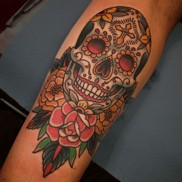 Traditional American sugar skull and rose tattoo by Chris Cockrill