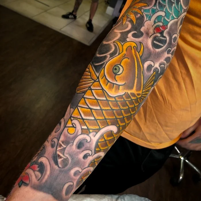 gold koi fish tattoo with waves in an irezumi style 