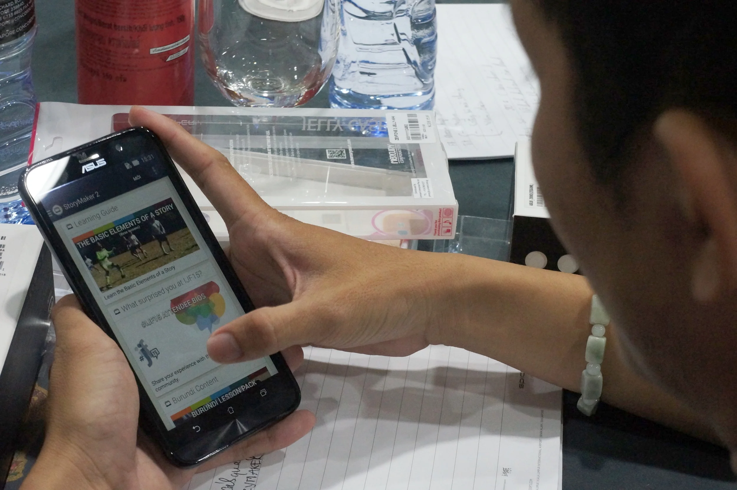 A participant of the citizen media training reviews the lessons on his smartphone. (Photo: Loa)