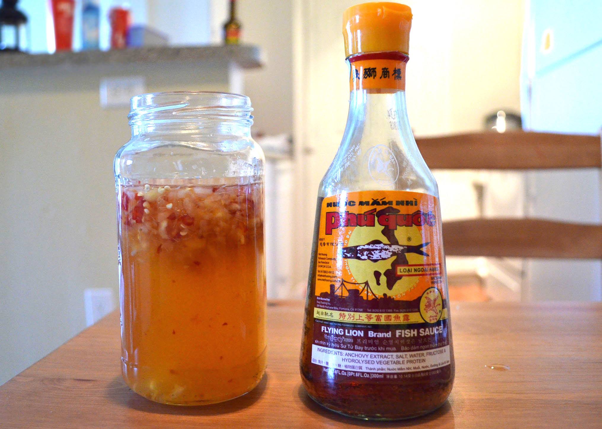 A jar of dipping fish sauce, or nước mắm chấm, next to a bottle of nước mắm from Phú Quốc. (Photo: Loa/Kathy Triệu) 