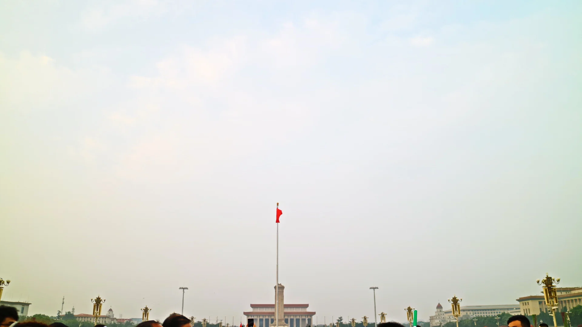  watching the flag-raising ceremony at Tiananmen Square  