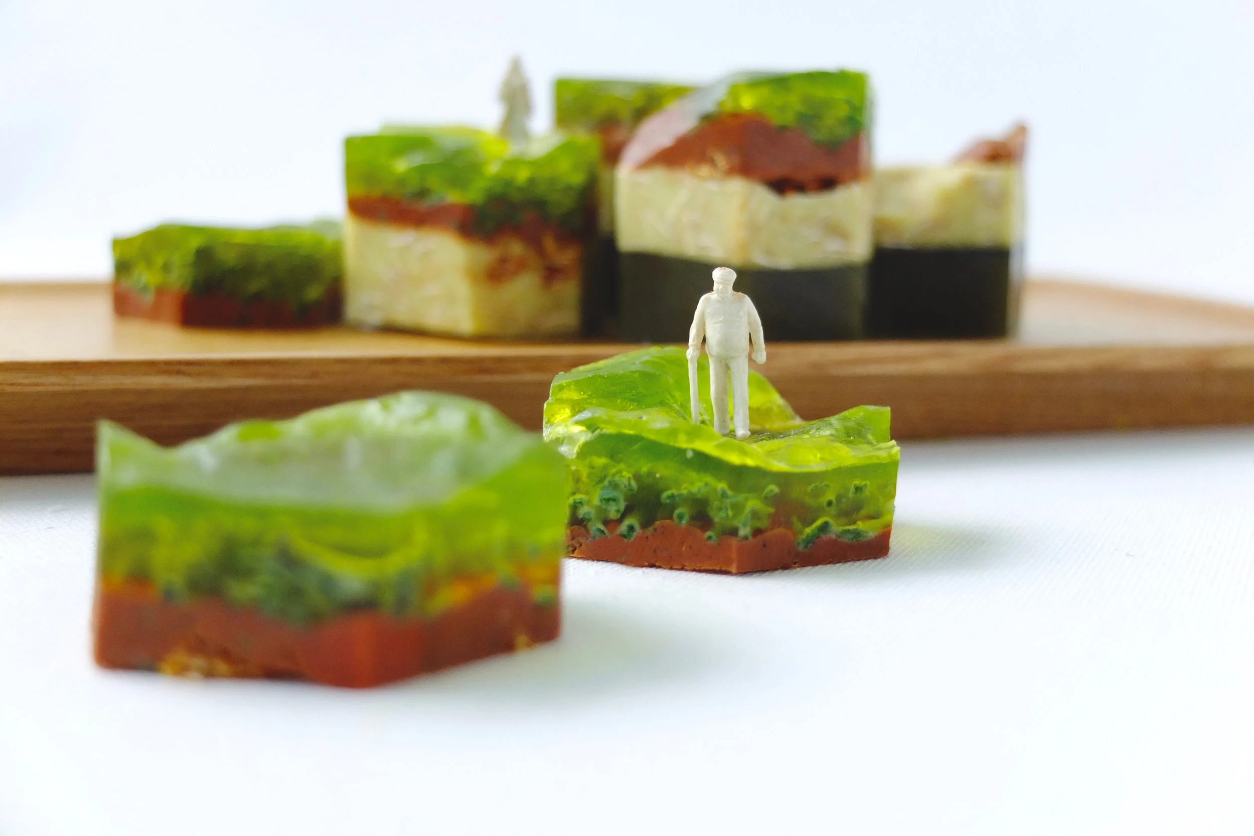 MONSOON RAINS Multiple layered soap. Various natural exfoliating bath fibers are mixed into the various scented layers of soap. The layers erode away with each shower, revealing a new surface of exfoliating texture and scent.
