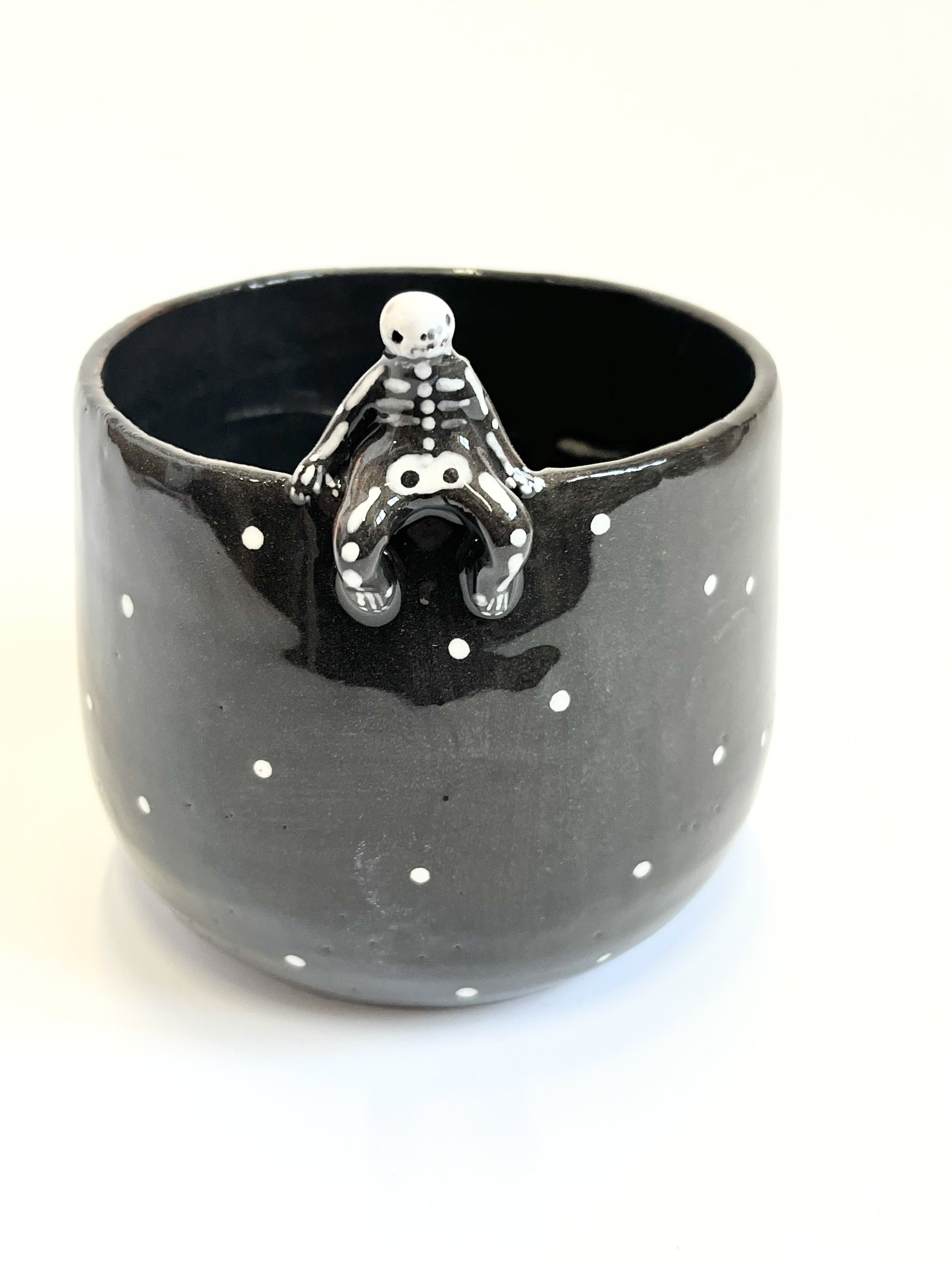 Oval bowl, with relaxing skeleton on the side, looking out at the world