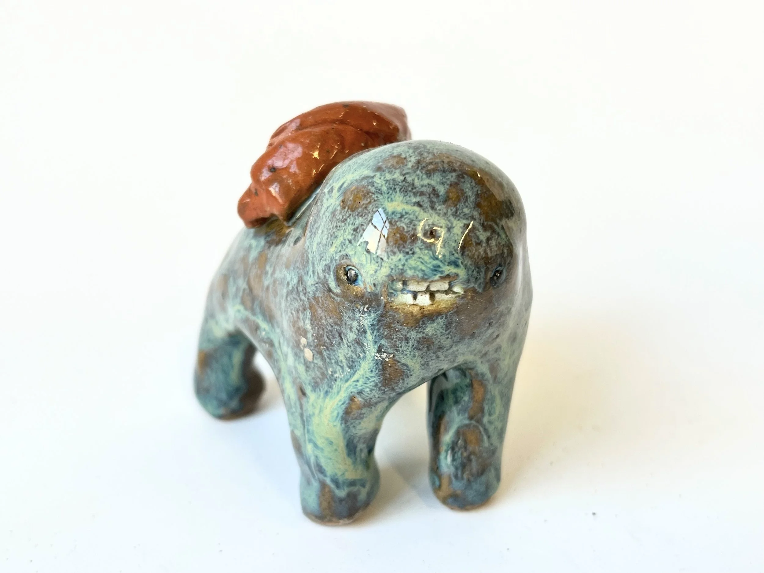 Mini Teethie, with gorgeous flowing green glaze and a delicious croissant on its back