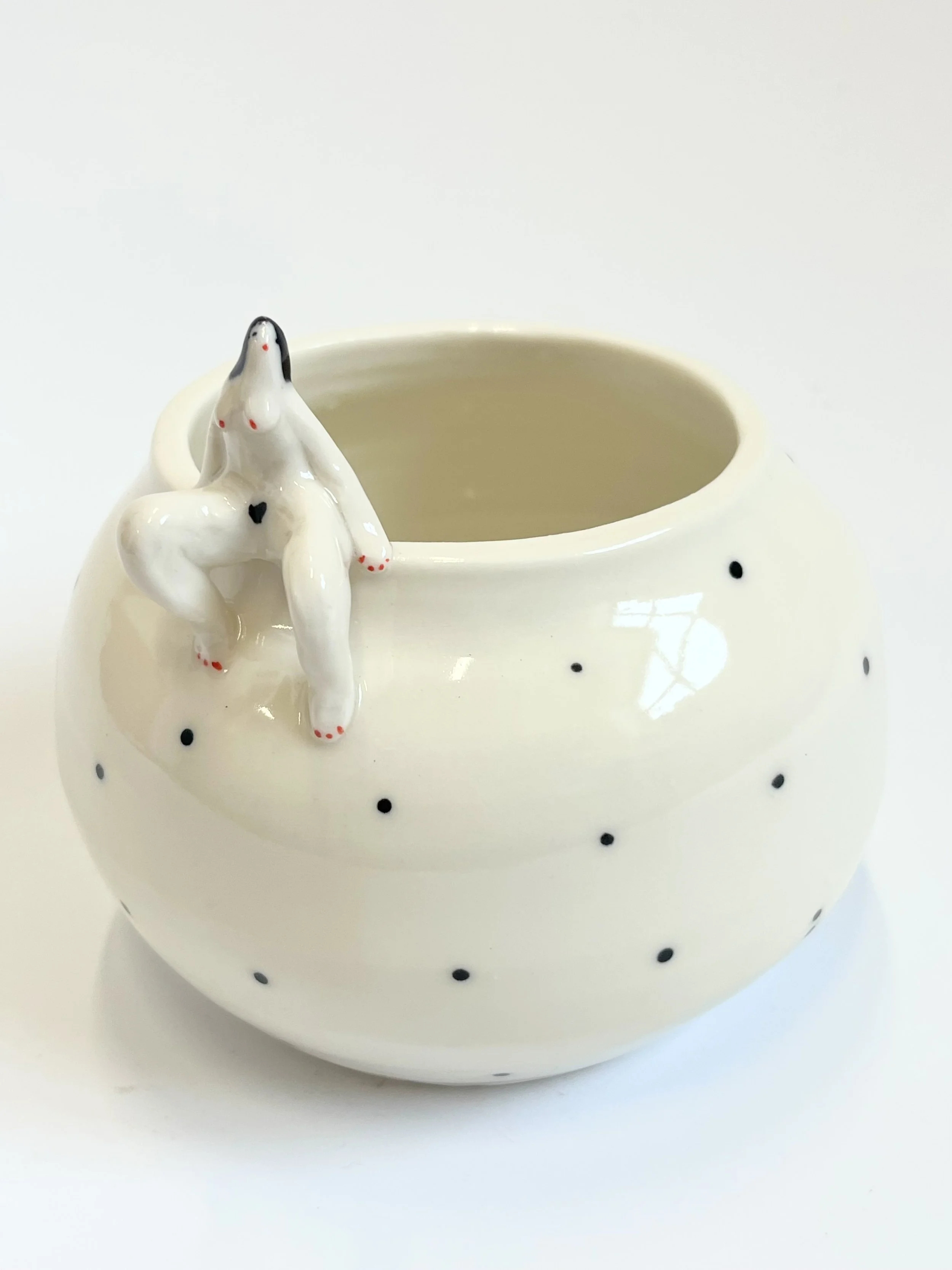 Oval porcelain bowl, with a tiny lady lounging on the side