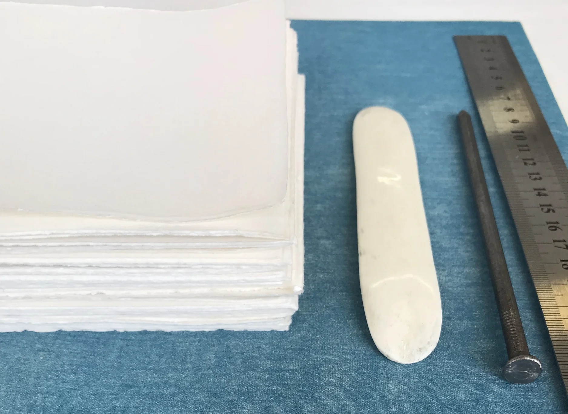 All ready for stitching. The blue fabric will be on my hardboard covers.
