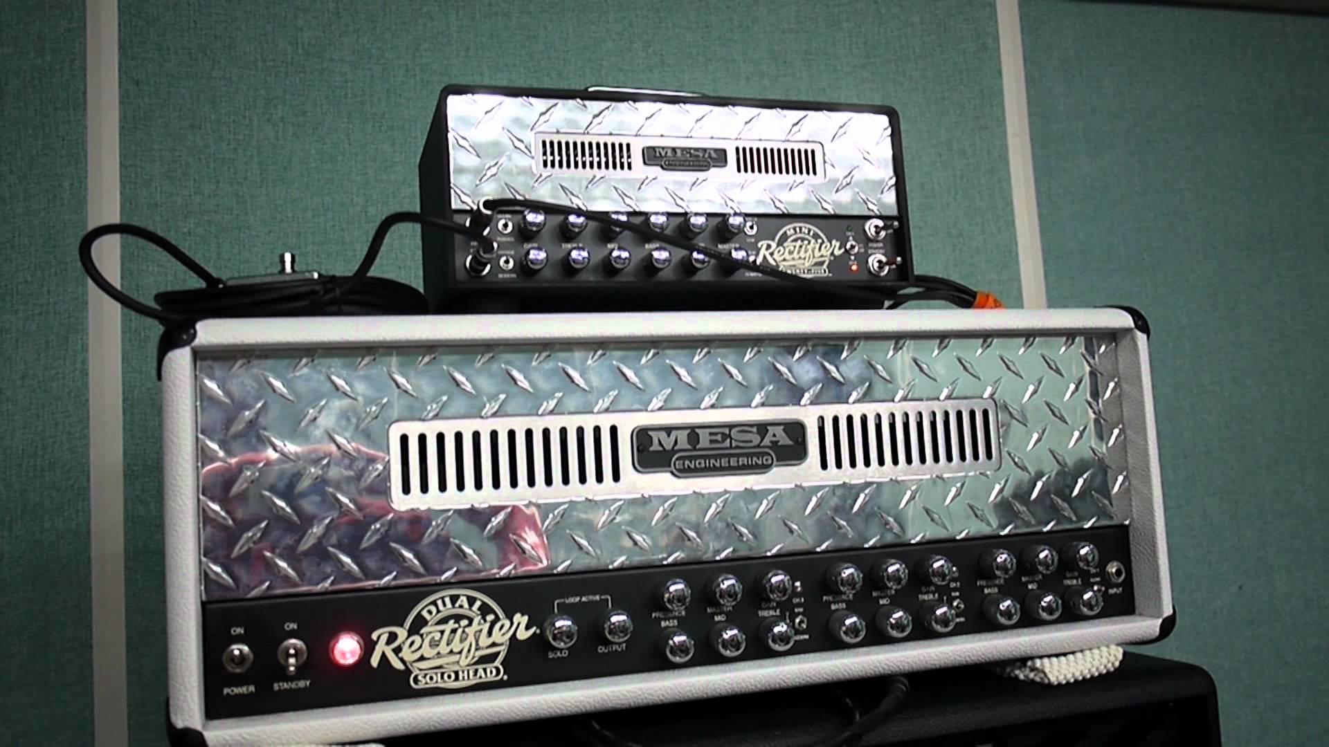 On top, the Mini Rectifier lunchbox amp from Mesa Boogie, sitting on top of it's big brother, the 100W Dual Rectifier. 