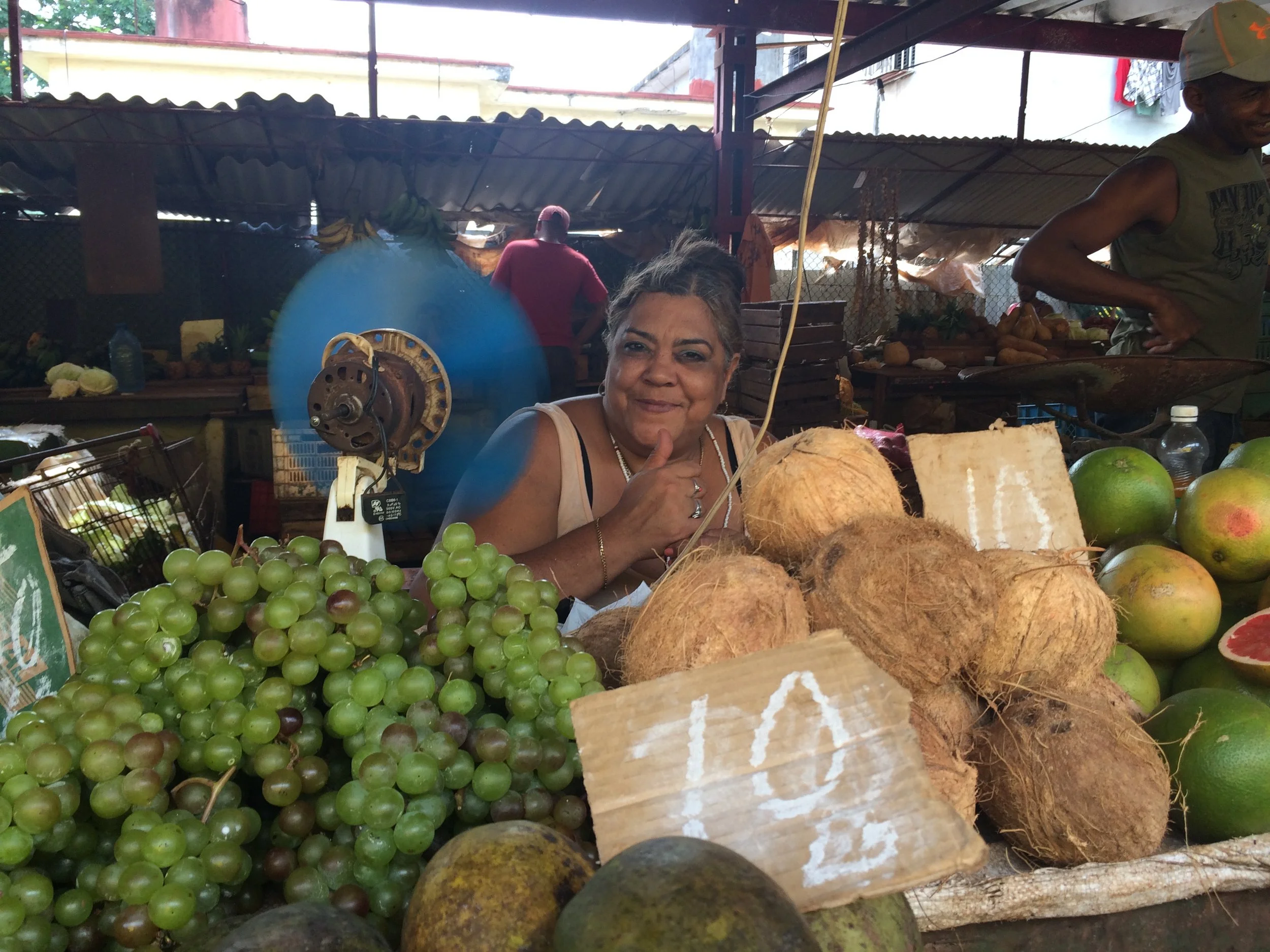 I love this vendor's fan, keeping her cool in the sweltering heat. 