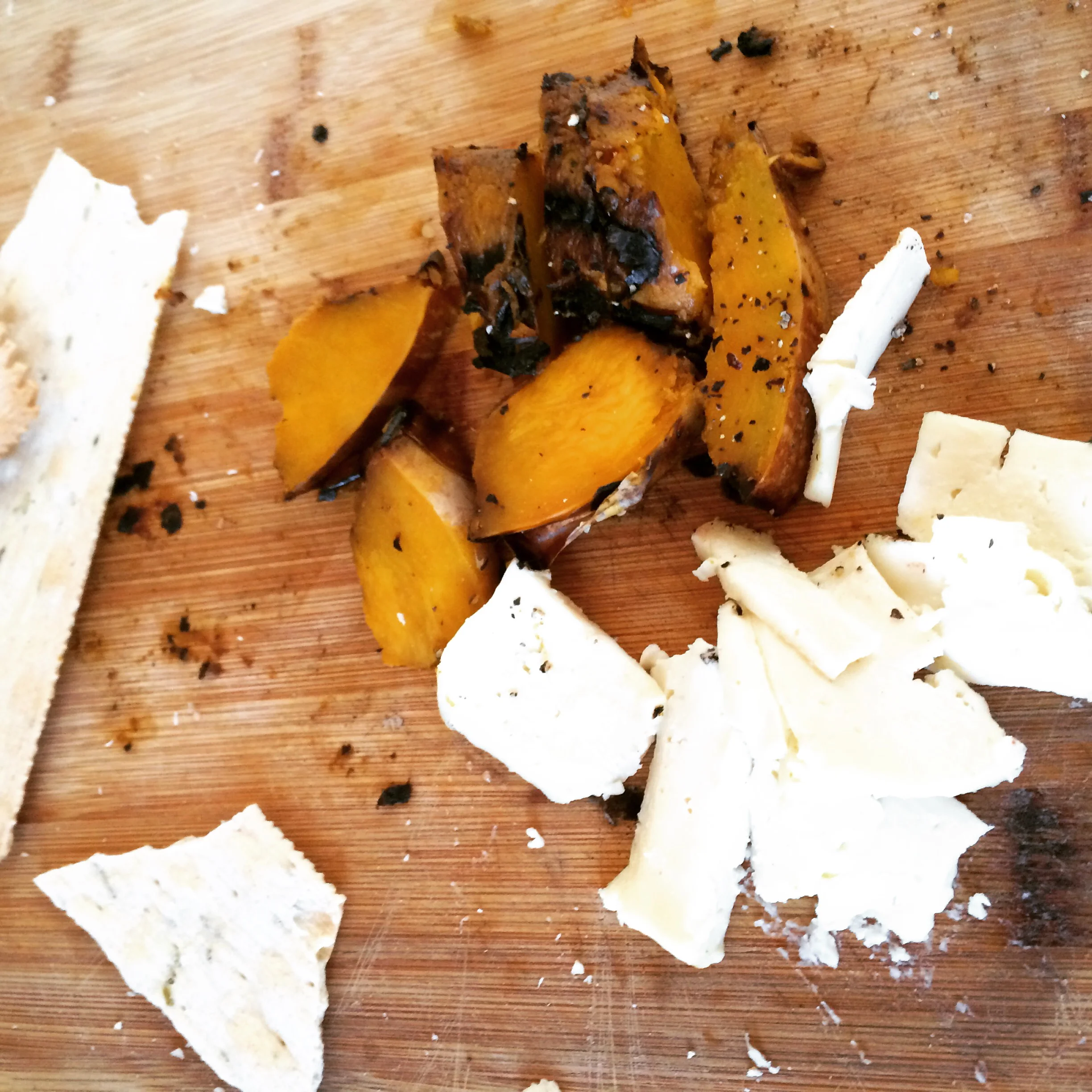 Leftover grilled butternut squash, queso blanco, and Trader Joe's crackers, served as an impromptu appetizer at our home. 
