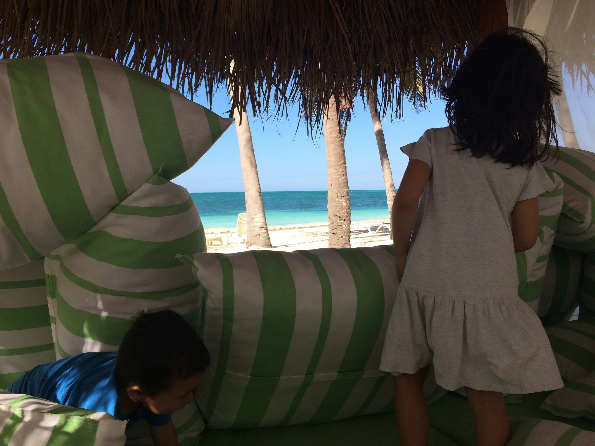 My kids building a fort in the cabana on the beach. 