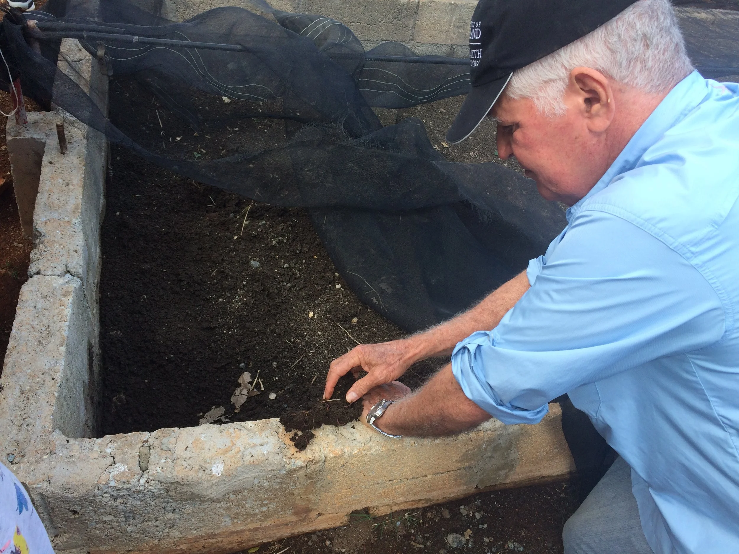 Miguel Salcines shows us the fertile organic soil he uses at his farm. 