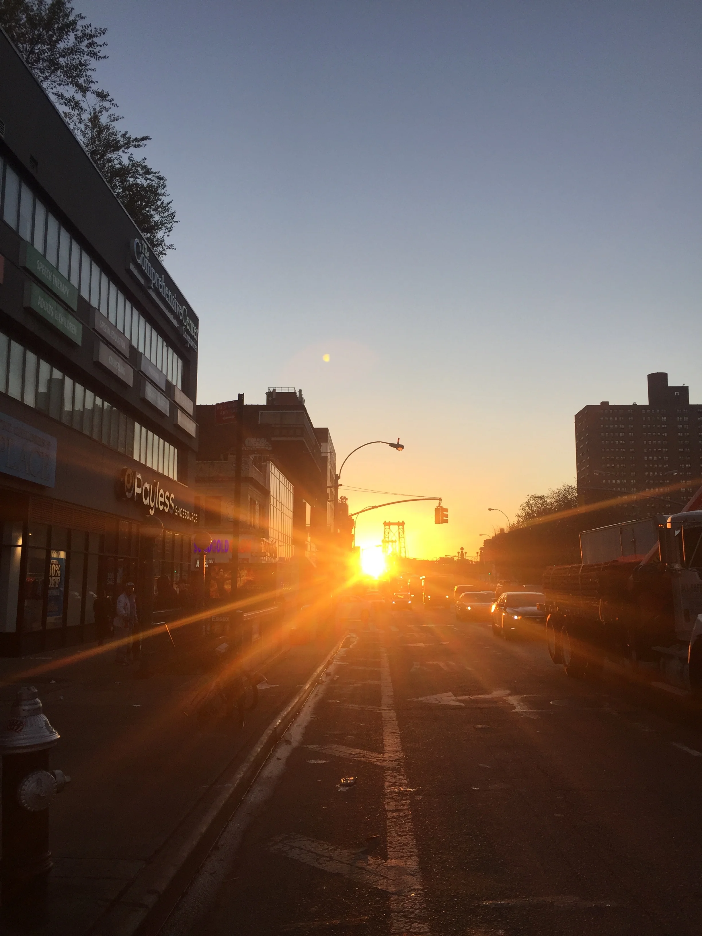 sun rising up the Williamsburg Bridge