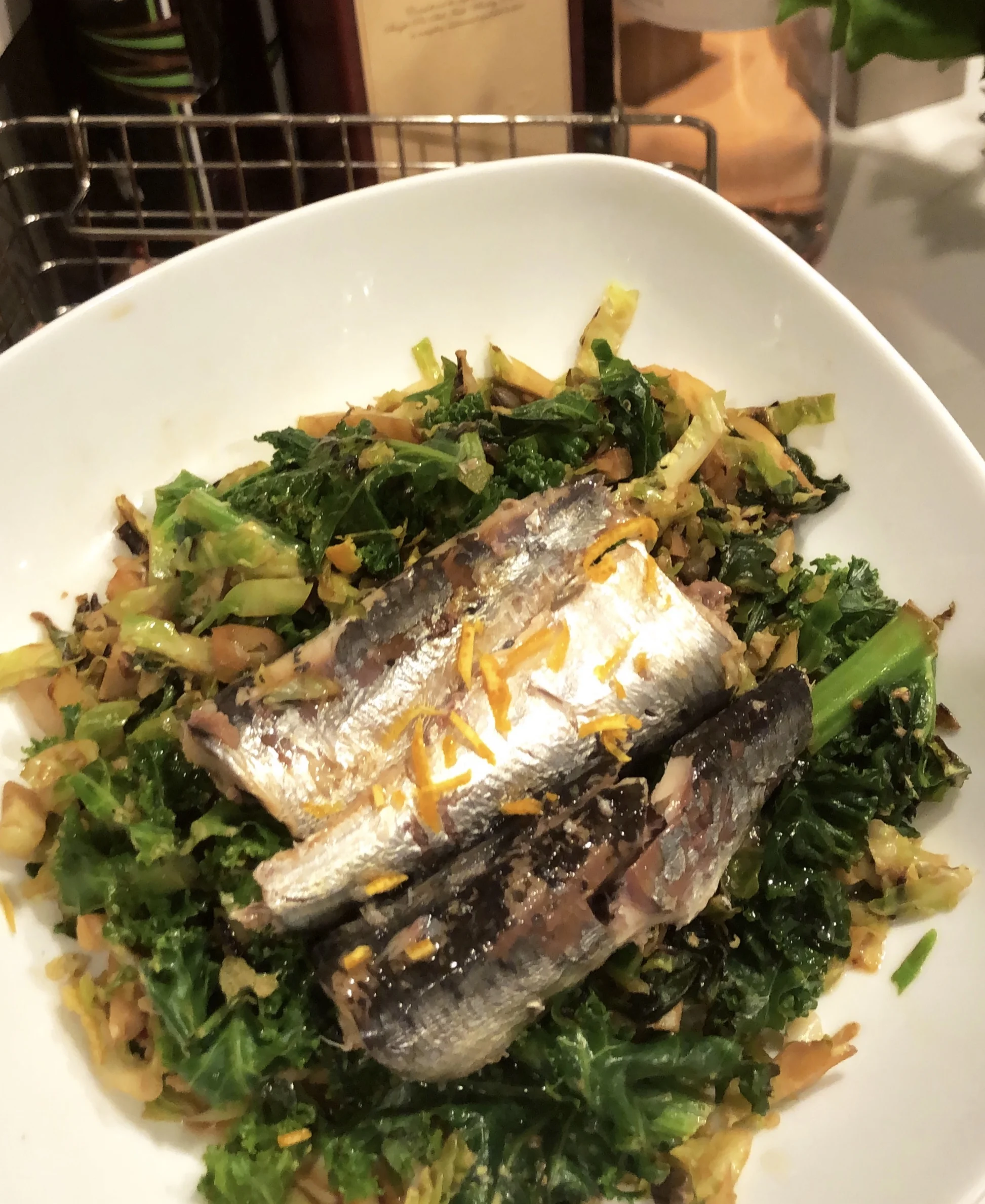Sardines. Sauteed kale, shaved Brussels sprouts, ginger + orange zest.