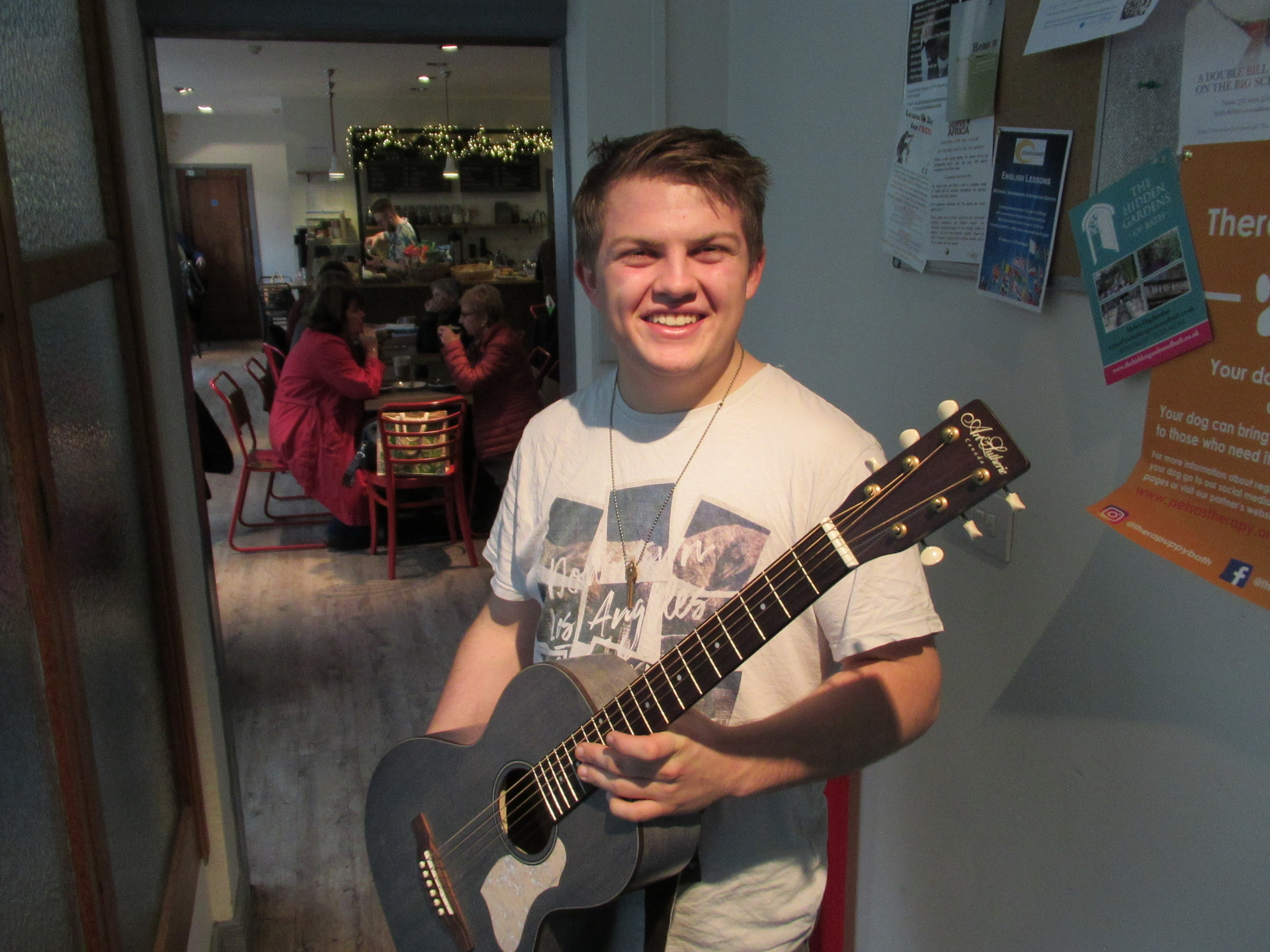 Bath Spa student Ed Axtell with the guitar provided by the William Cross Foundation
