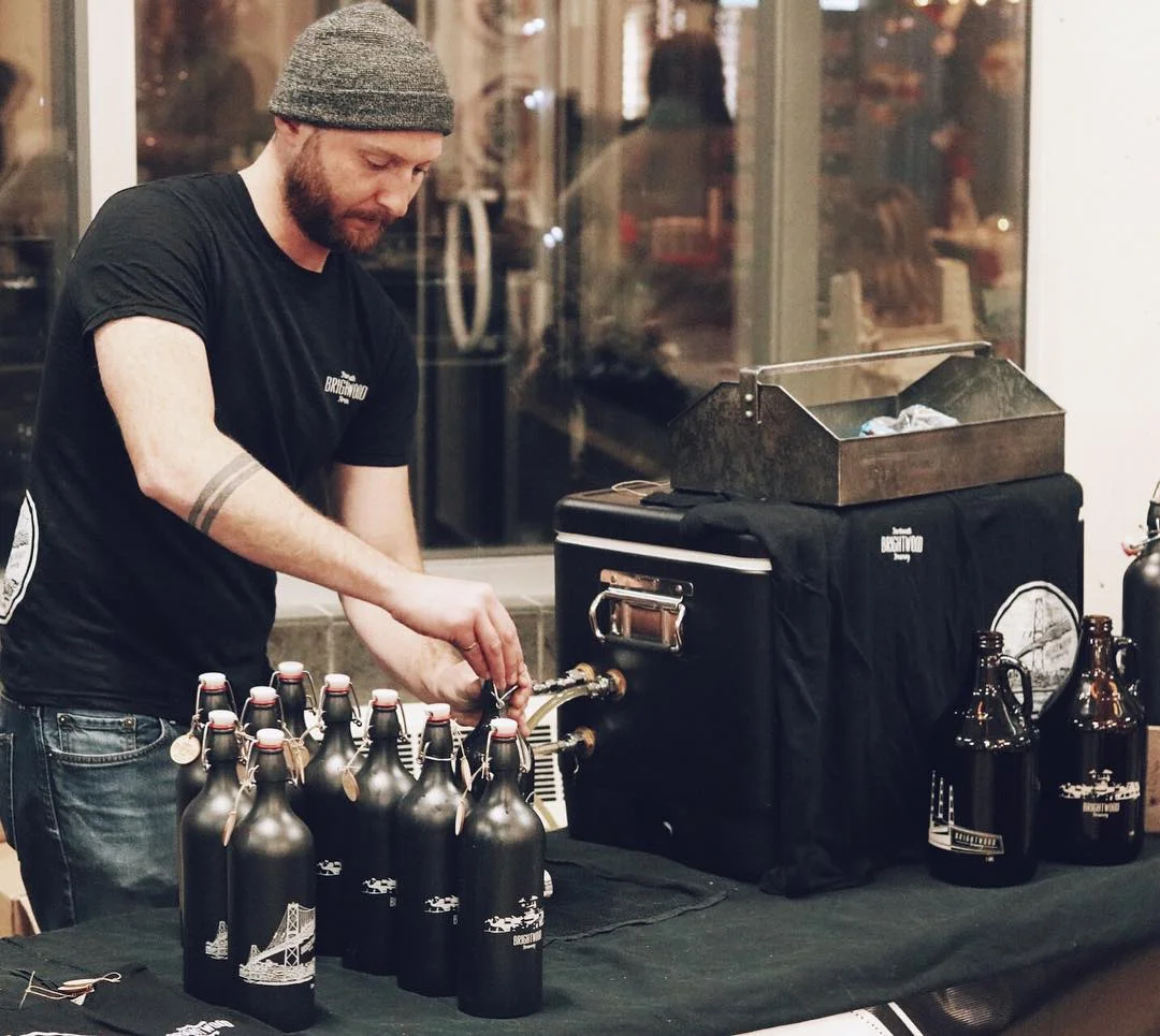 Ian doing growler fills/ keeping his head toasty