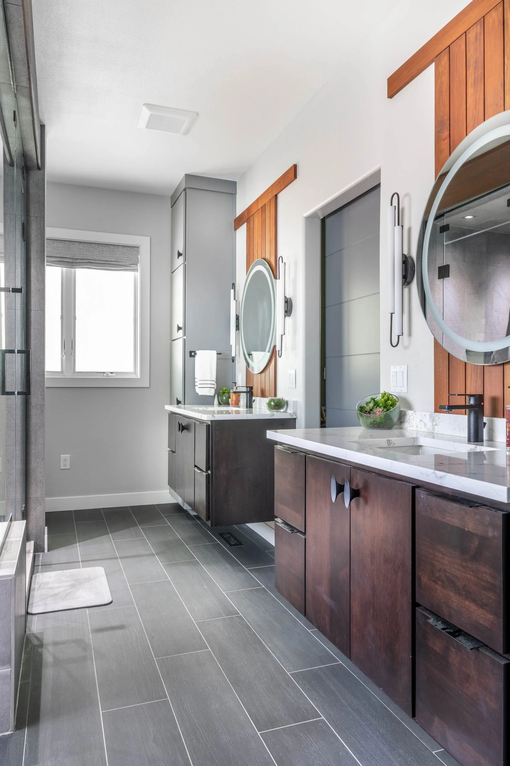 A wide-angle view of both vanities capturing the symmetry between them.