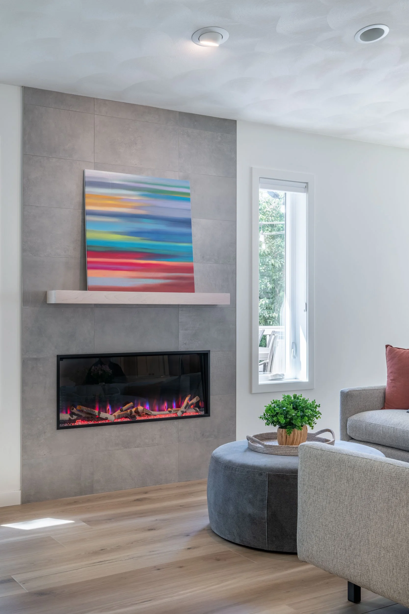 Focused view of the living room capturing the new Heat n Glo electric fireplace with the Trends In Ceramic tile surround & mantle.