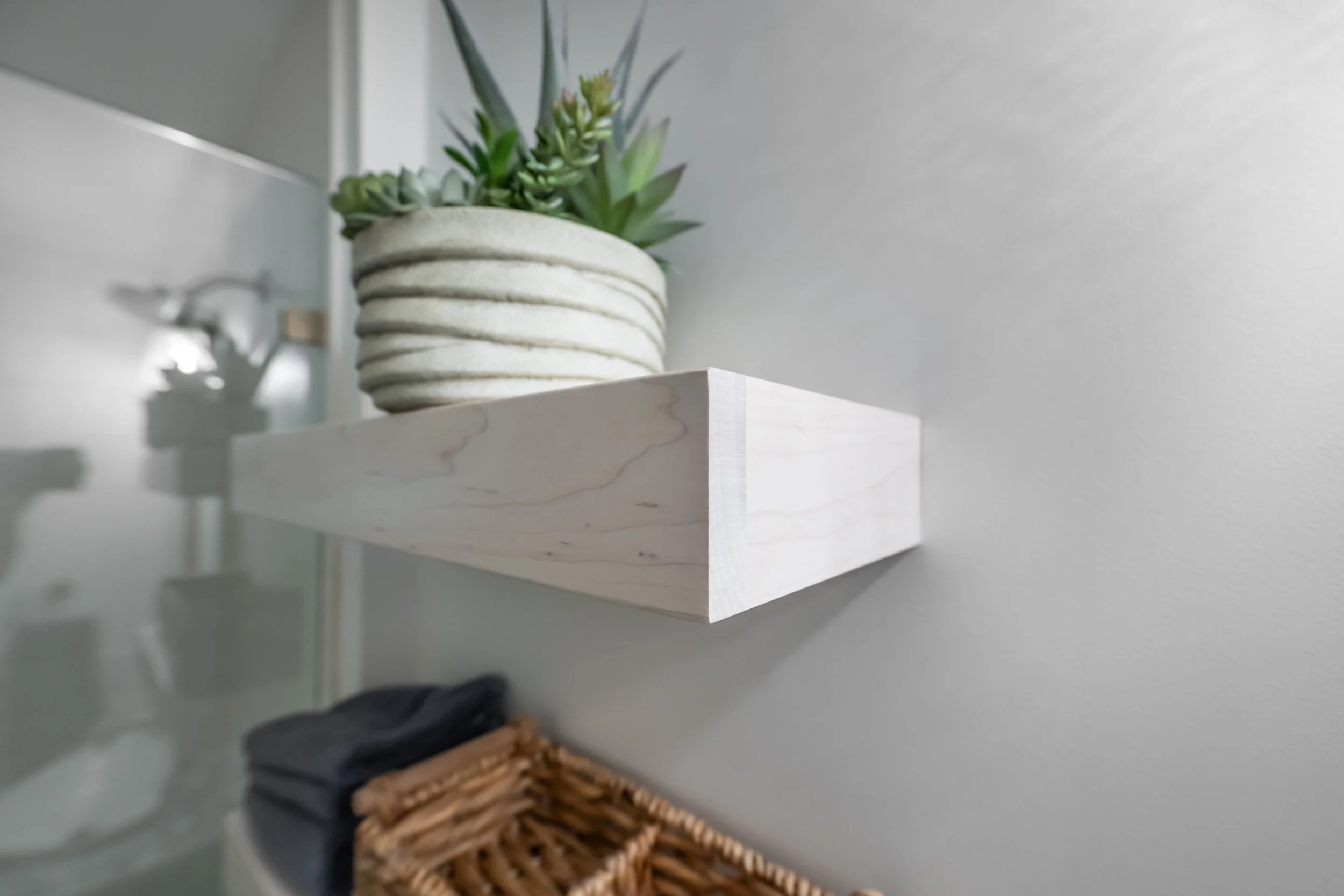 Close up view of the floating shelves above the toilet