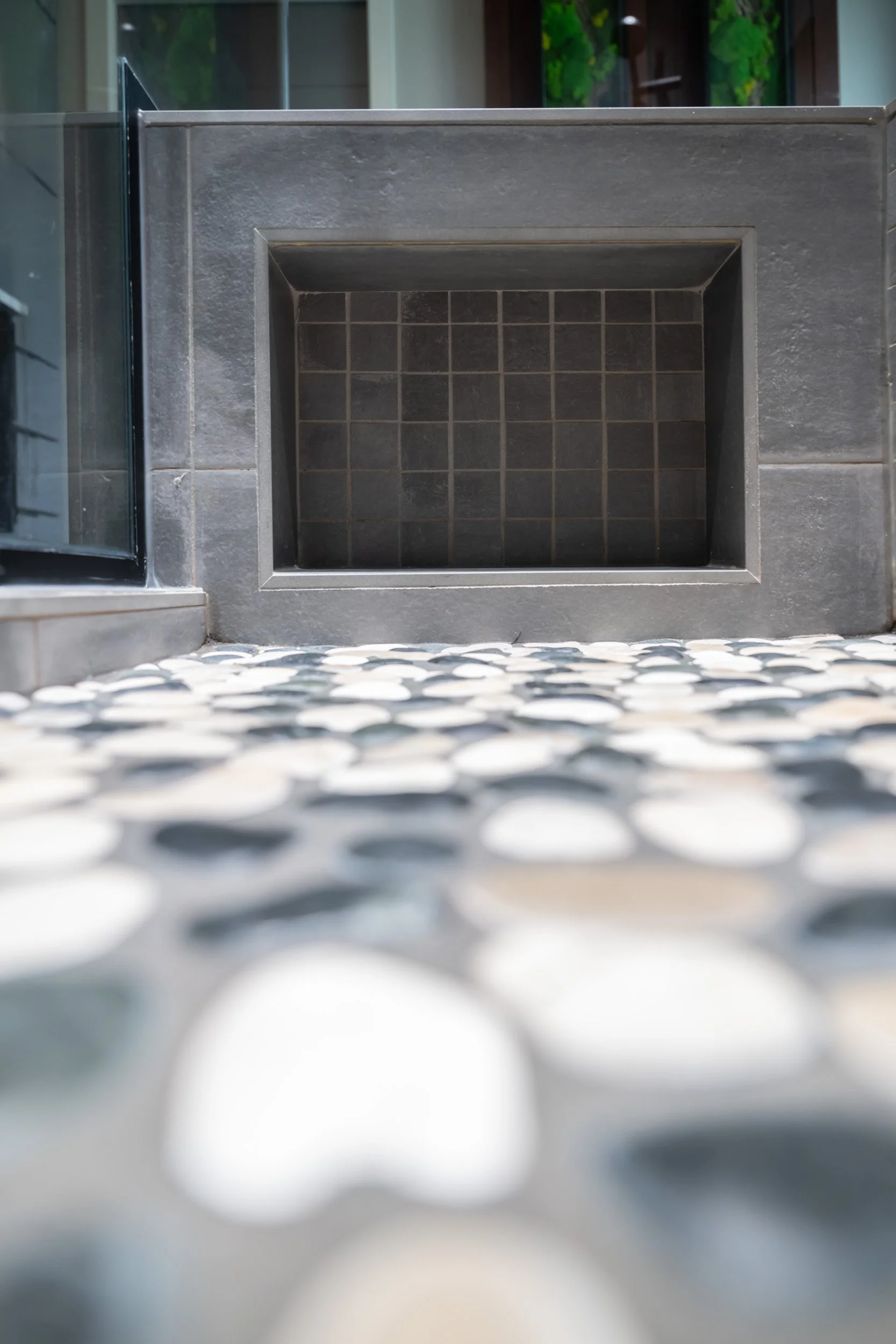 A close-up view of the hidden tile niche located in the shower bench