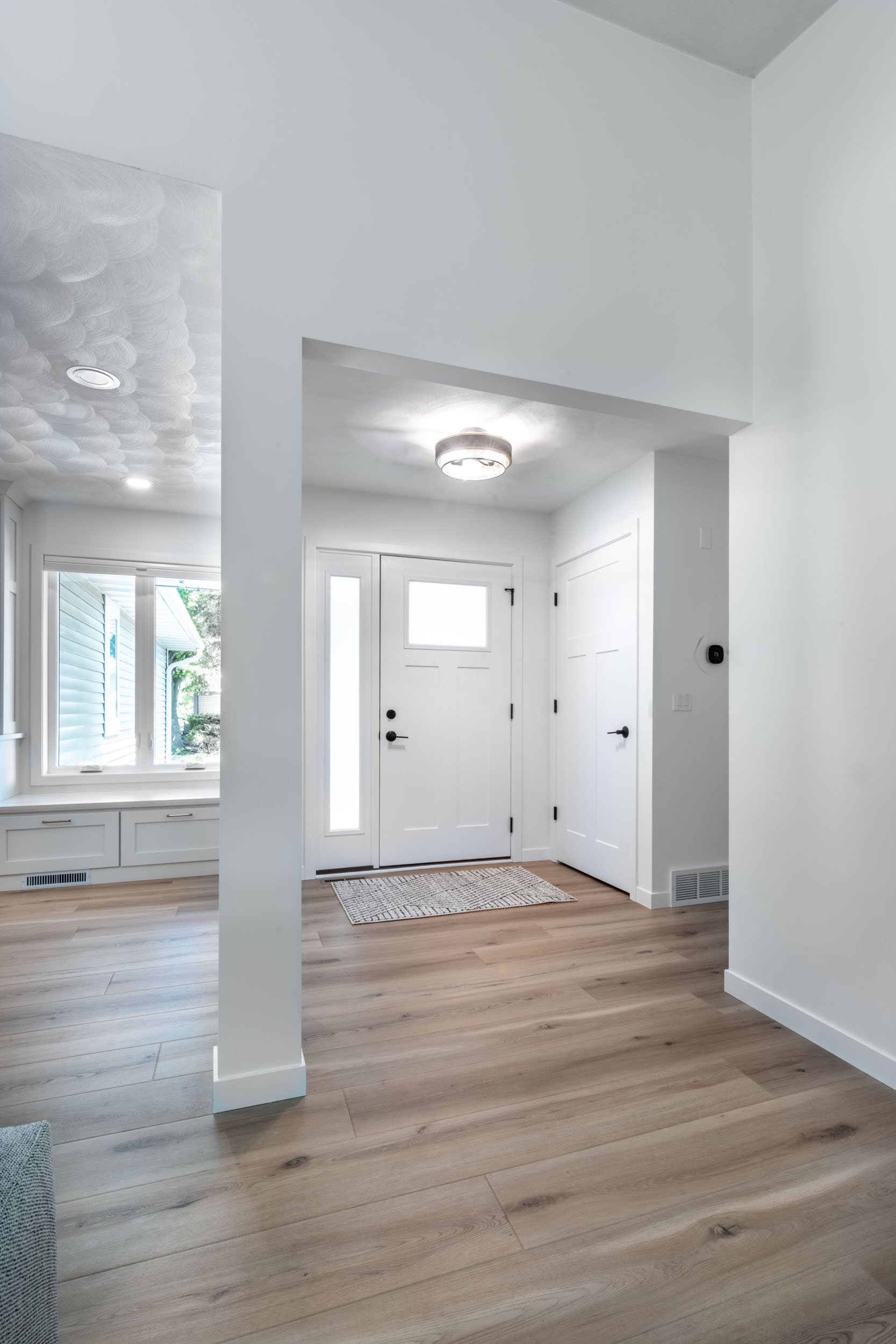 Focused view capturing the front entry foyer, featuring the new Drexel Blue Door front door