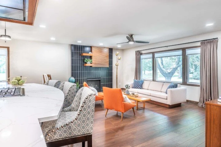 A midcenturly inspired great room with a black fireplace tile